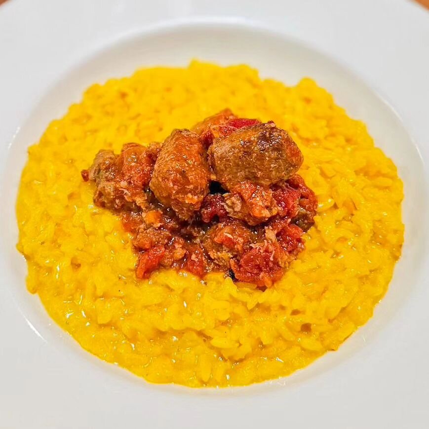 Escape this rain day with a bowl of our Monzese Risotto. This classic Monzese Risotto will be our featured risotto. The risotto itself is cooked with saffron and parmesan. Then we topped the risotto with Italian sausage cooked in tomato sauce. 

Lunc