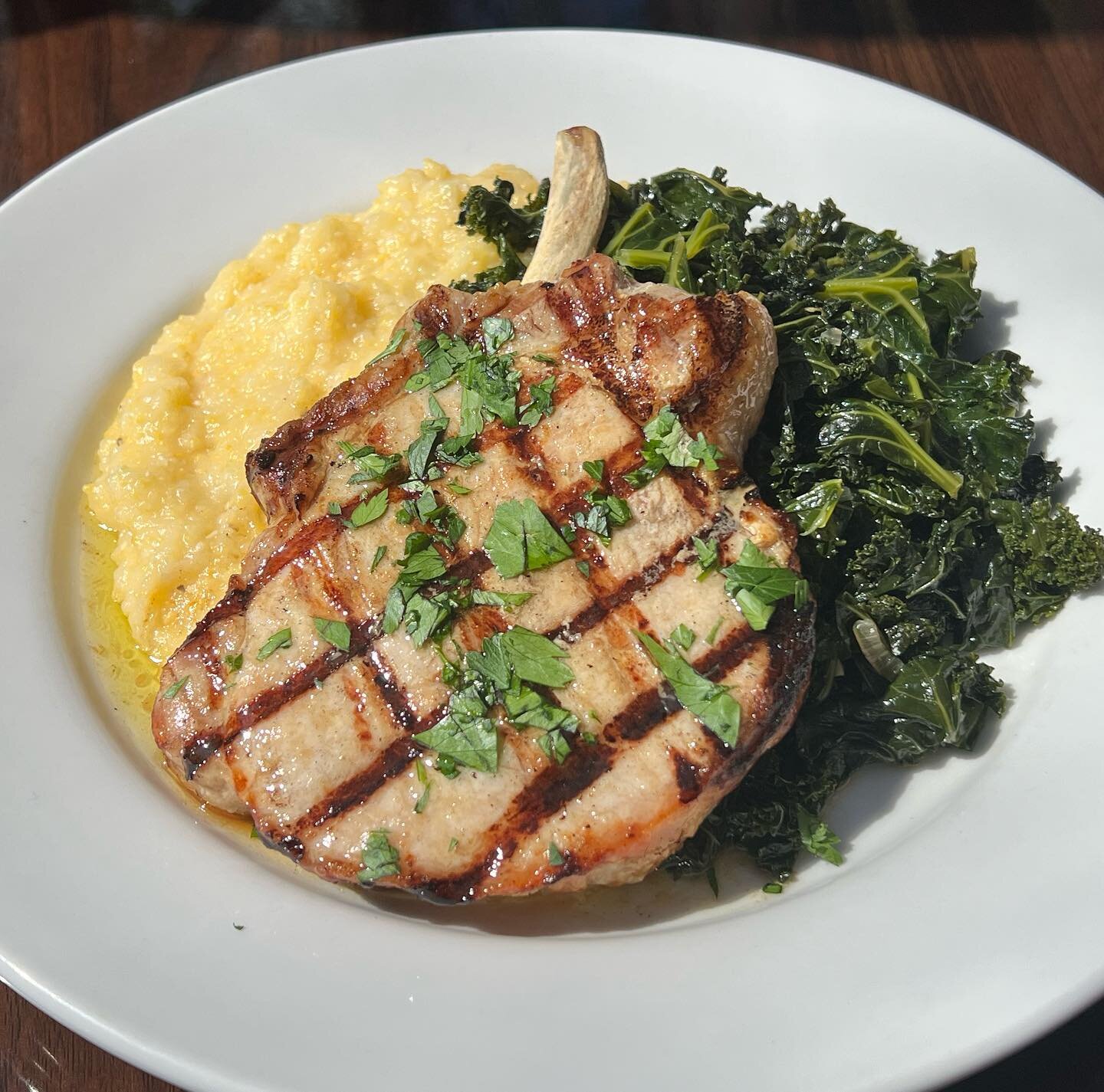 Bone in Pork Chop, creamy polenta and braised kale 🎤 

#l&eacute;fresca #porkchops #boneinporkchop #downtownbham #northenitaly #italianfood