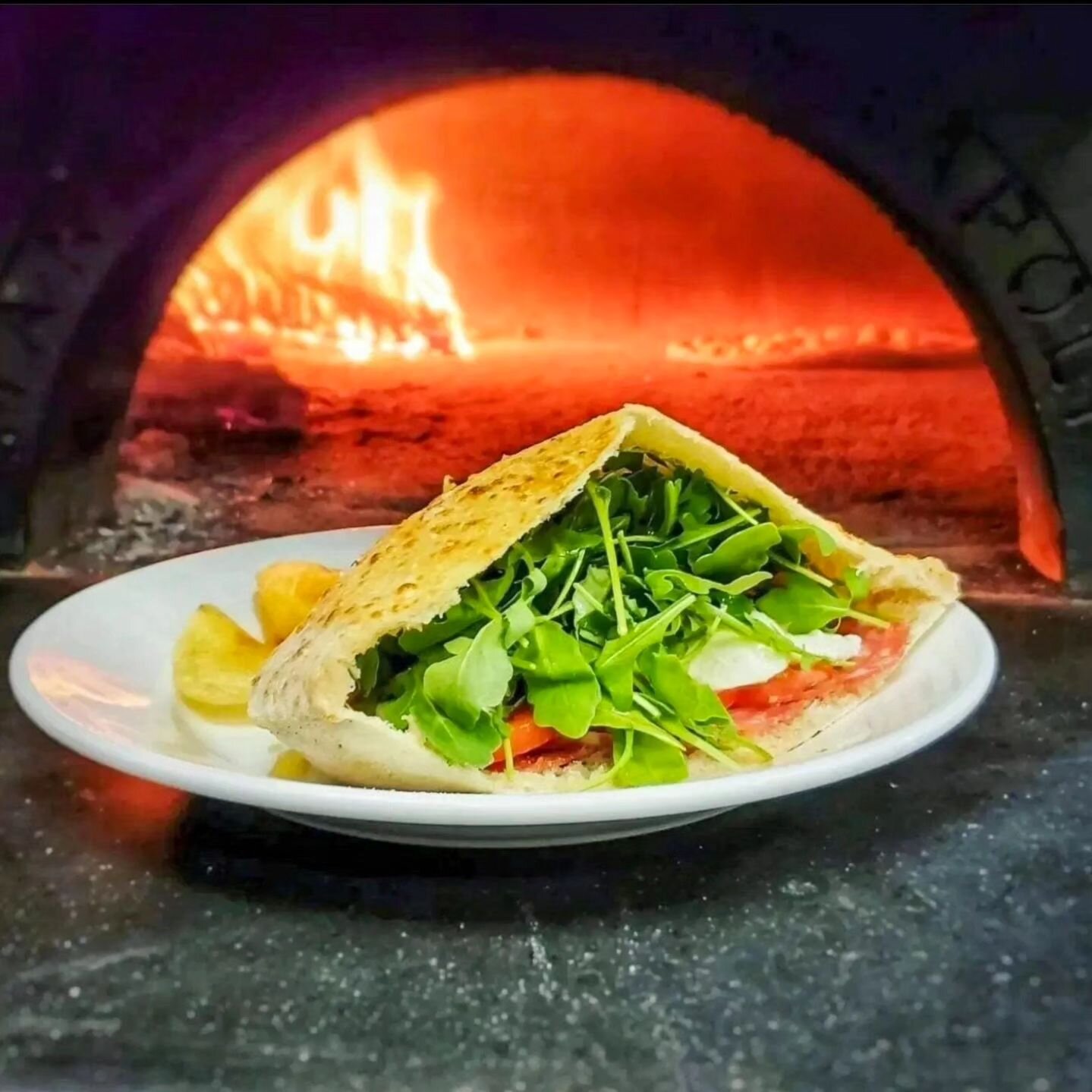 Escape this rainy day with one of our piping hot lunch sandwiches. With every order, we bake the bread fresh from our pizza dough, which uses imported Italian flour. We then fill the sandwich with salami, tomato, mozzarella cheese, and arugula. Each 