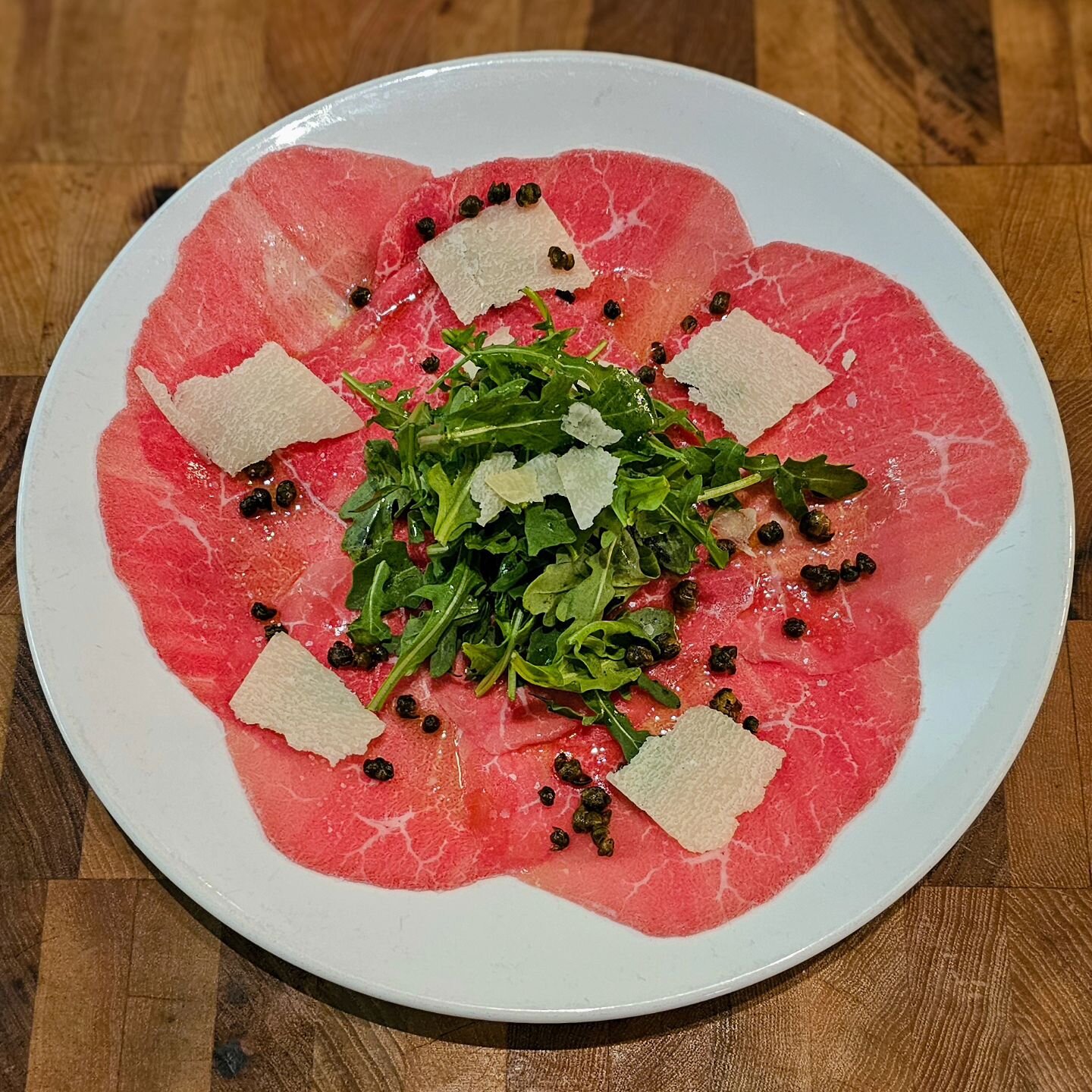 One great way to start an Italian meal is with our beef carpaccio. Here, beef is shaved paper thin and then fanned across the plate. We then add arugula, parmesan cheese, and fried capers to finish the dish. 

We are open for lunch and dinner Tuesday