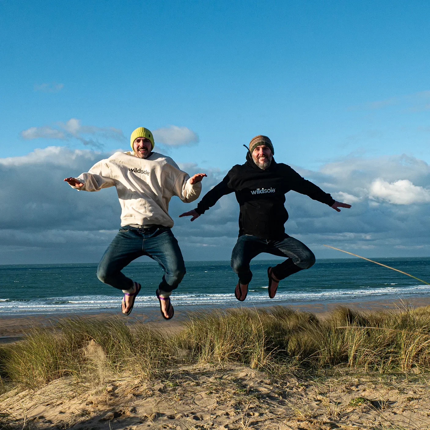 wildsole co-founders Tom and James jumping in Cornwall