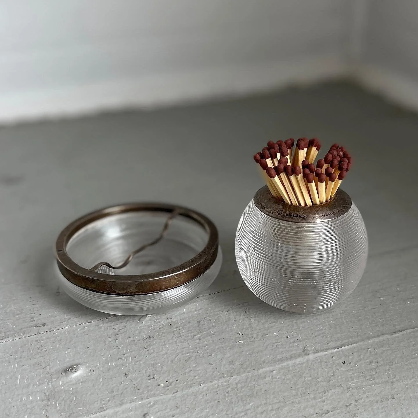 On Sale!

Fabulous deco match-strike and ashtray set. Marked sterling silver rims.  It&rsquo;s not everyday you have a set of these! Bites to the match strike ribbing. 
.
2.25&rdquo; tall 
Was $225 for the set
NOW $180
.
.
.
.
.
.
.
.
#decomatchstric