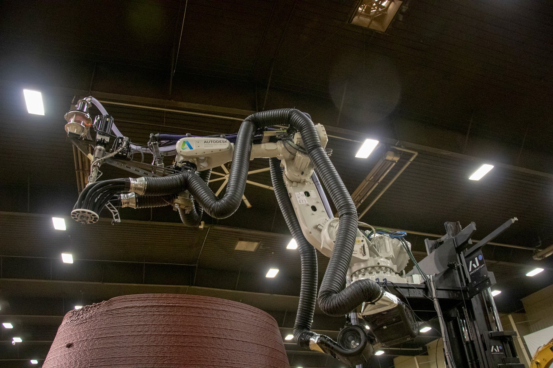 Robotic arm 3D-printing a prototype habitat shell during NASA’s 3D-Printed Habitat Challenge.