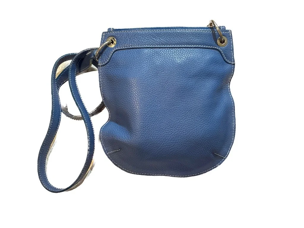 Back view of Rossi & Caruso blue pebbled leather crossbody bag featuring exterior slip pocket and contrast stitching.