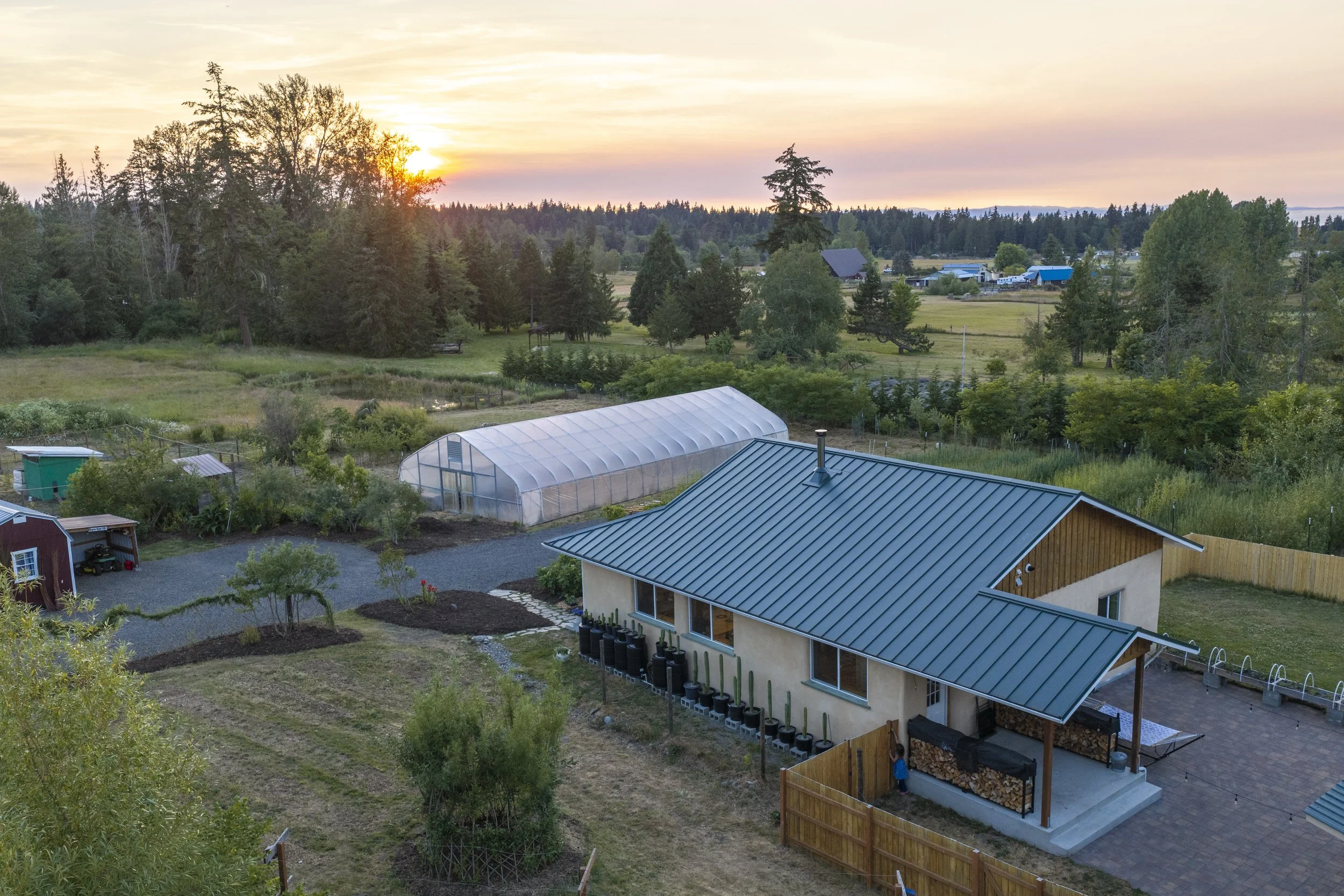 be-easy-farm-straw-bale-home-regenerative-homestead-sequim-wa-aerial-sunset.jpg