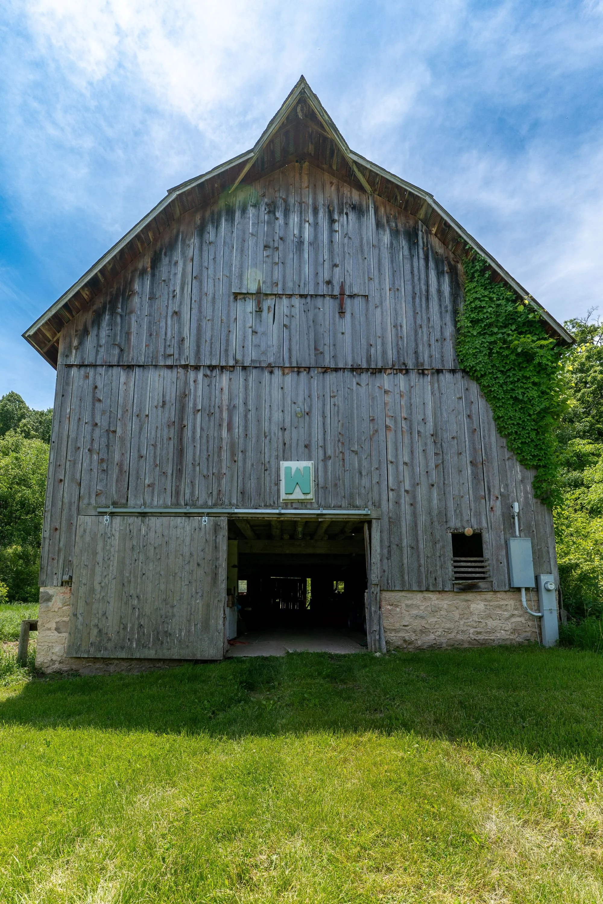 A well-preserved barn on a 1920s stone foundation.