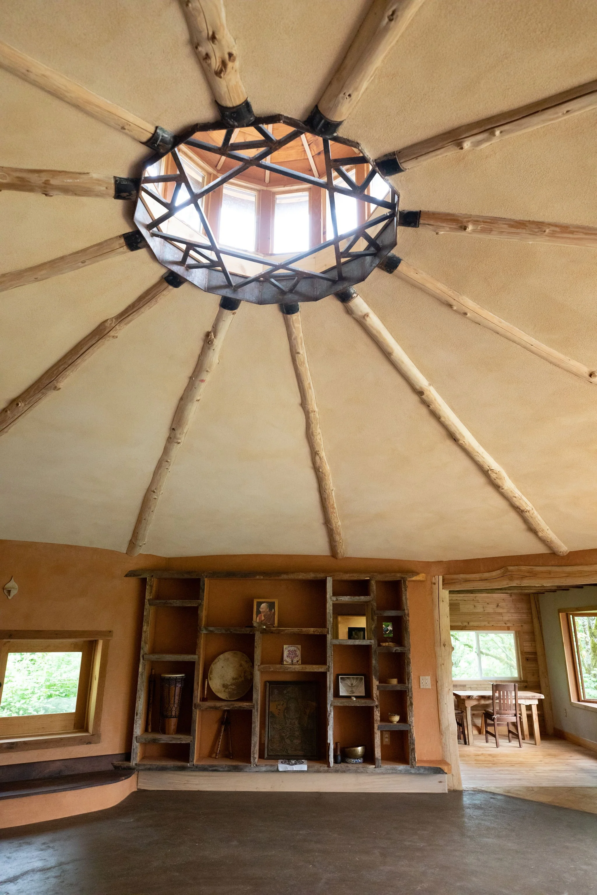 A stunning interior of Kinship natural building that blends natural colors and raw materials into an immersive room that celebrates the nature that surrounds it.