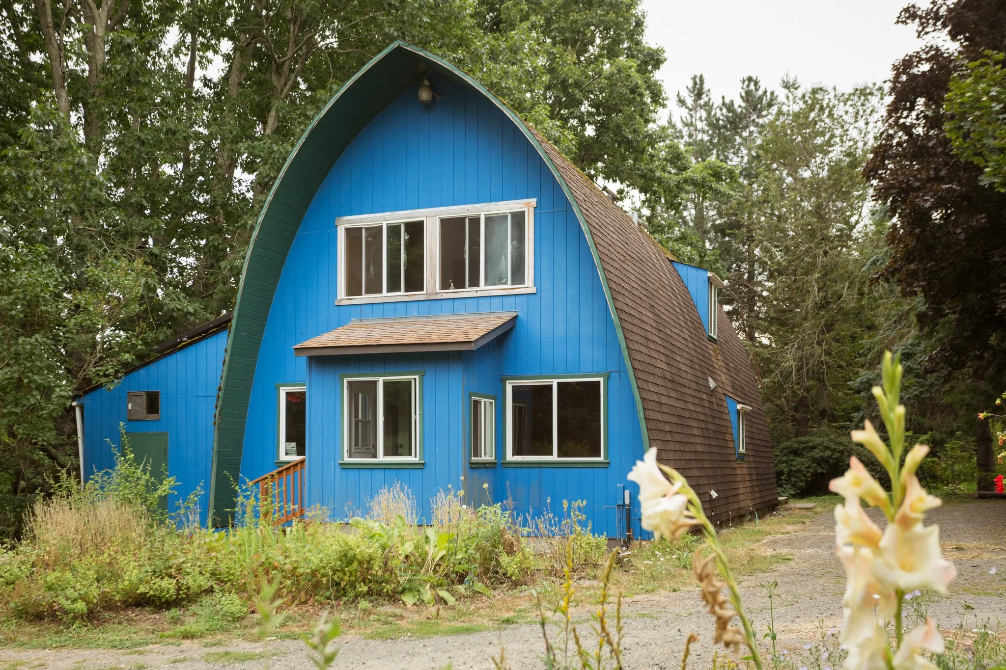 A blue, arch-shaped house in Stone's Throw, Oregon
