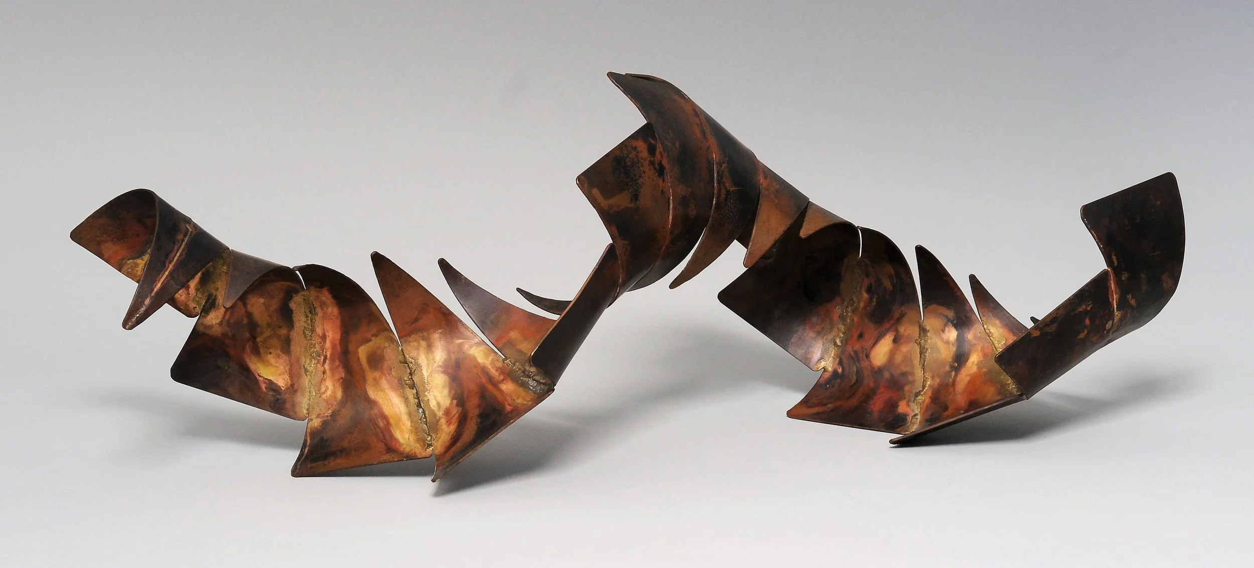GO WITH THE FLOW (Triangular Curve Series #21) (c)1985; Copper, bronze; 9h x 26 x 10 inches