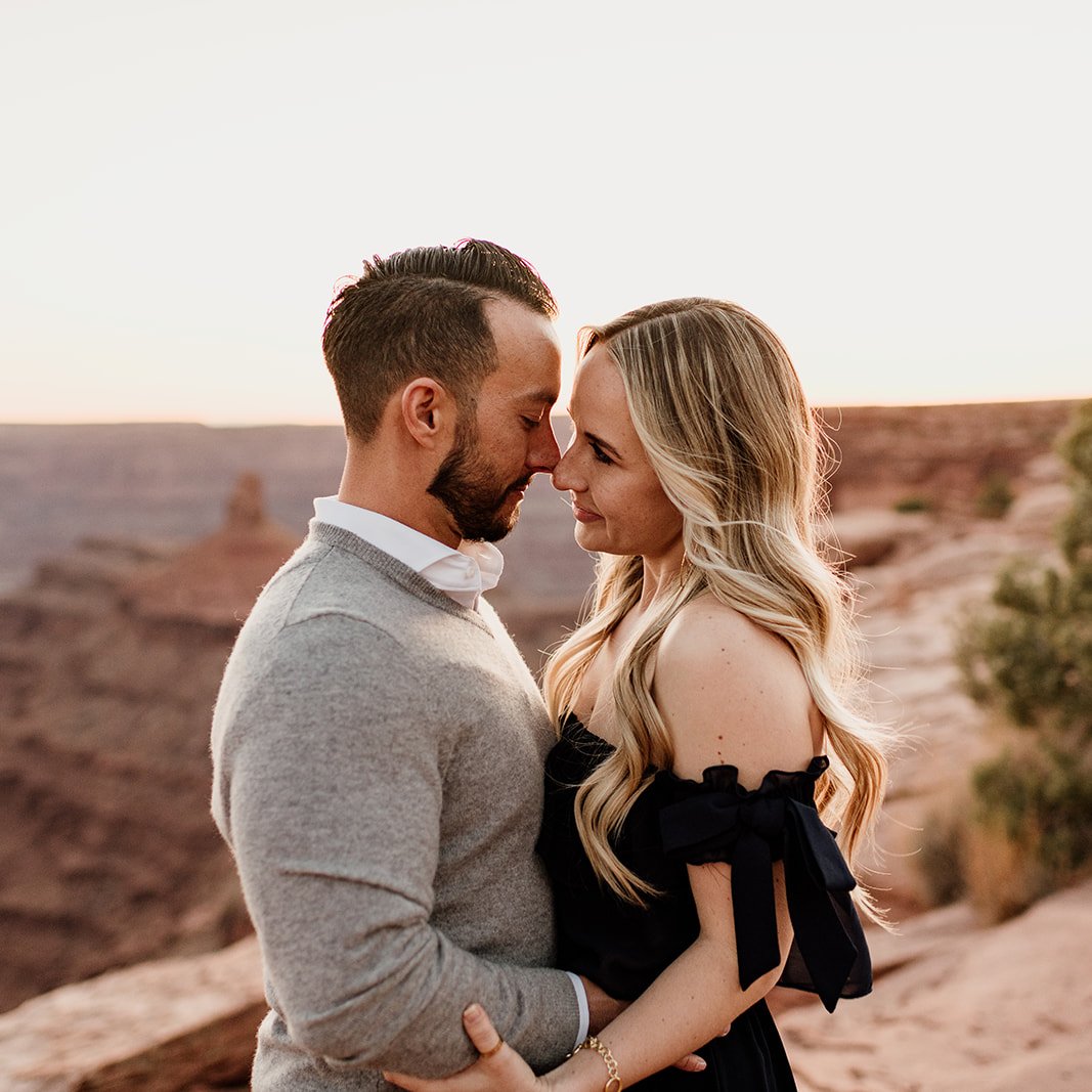 Couple Almost Kissing While Standing on a Lakeshore · Free Stock Photo