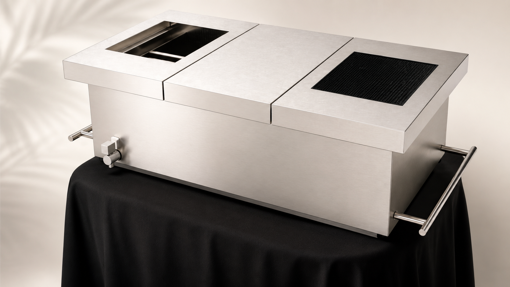 Stainless steel commercial kitchen salamander broiler with adjustable knob and handles, placed on a black tablecloth.