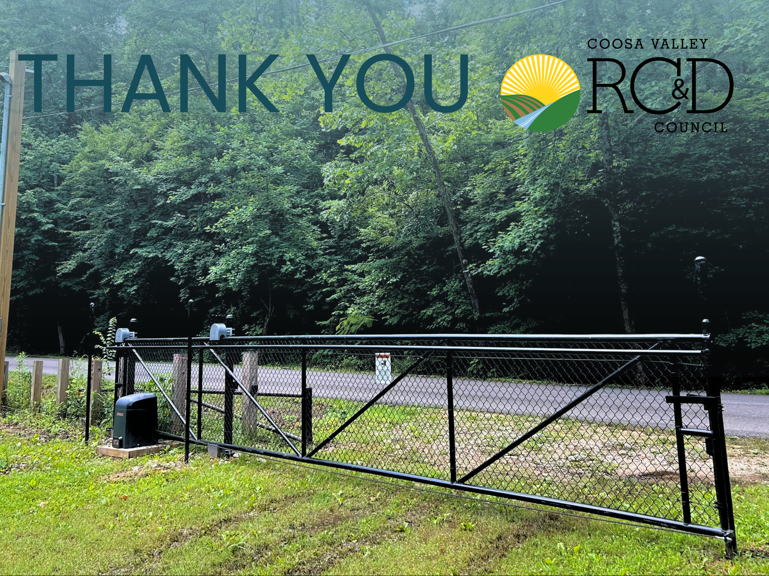 An image of the new automatic gate at Weaver Cave Preserve with text thanking Coosa Valley RC&D. In the background beyond the gate there is a road and a forest