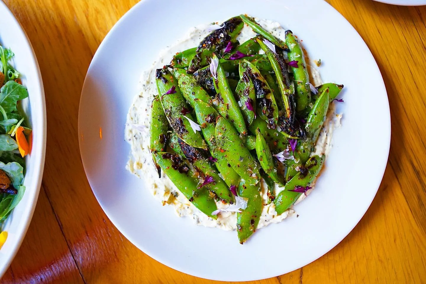Summer freshness on a plate - Blistered Snap Peas with a cool Fromage Blanc, fresh Mint, citrusy Lemon Oil + Sea Salt. Wash this down with a crunchy crispy white wine, and start this hot weekend off right!