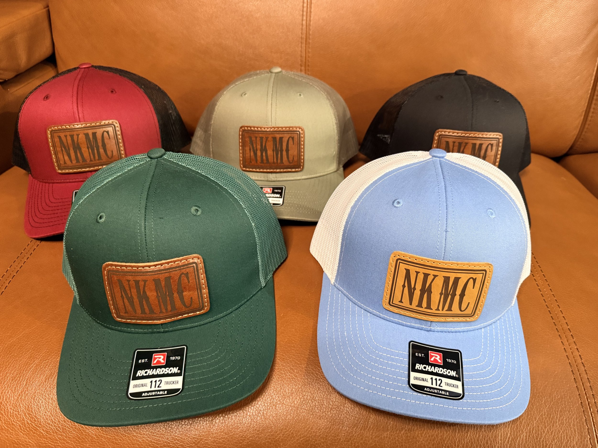 NK member trucker hats available in multiple colors