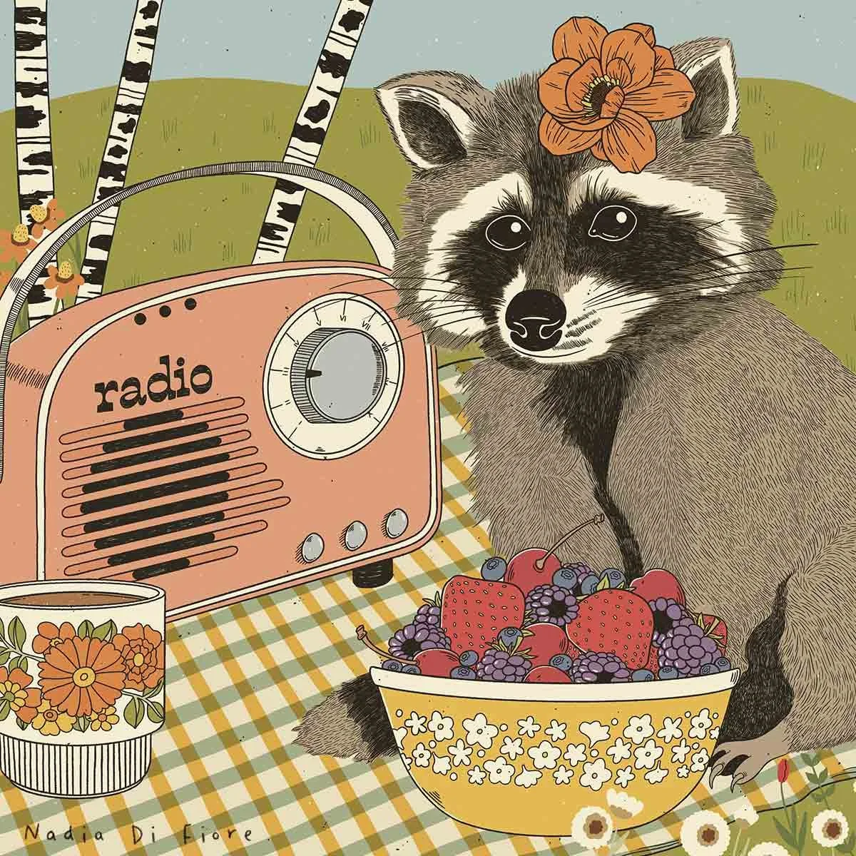 Contemporary folk illustration of a raccoon with a flower behind her ear, sitting on a gingham blanket with wild berries, a floral mug, and a vintage radio among birch trees and wildflowers. A wildlife illustration by Nadia Di Fiore.