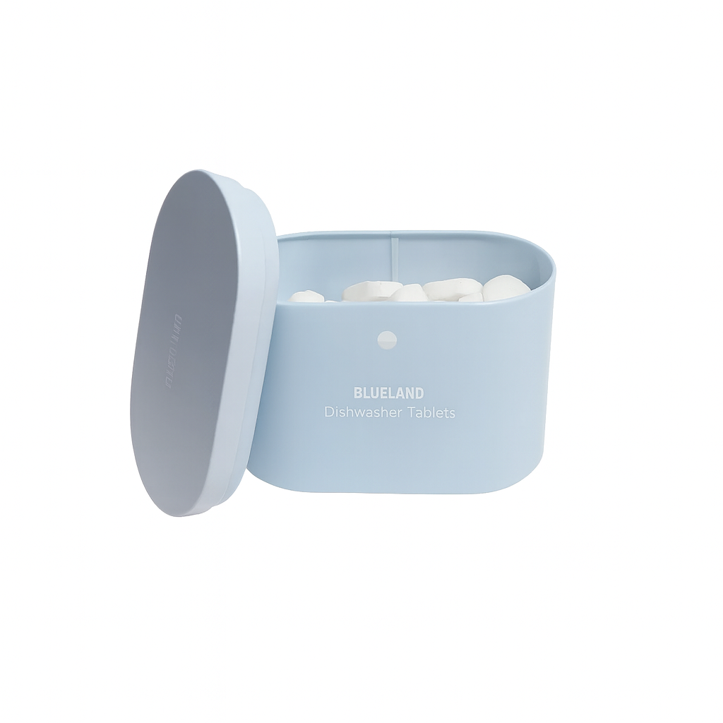 Blueland pastel blue dishwasher tablet container with lid propped open, showing white plastic-free tablets inside — reusable tin designed for eco-friendly kitchen storage and low-waste cleaning routines.