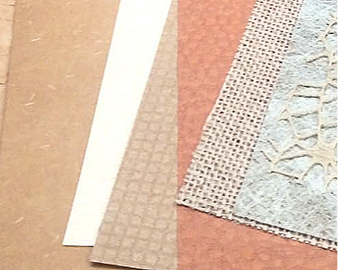 Textured and patterned paper sheets in earthy tones of brown, beige, and cream arranged side by side, featuring embossed designs, fibrous textures, grid patterns, and lace‑like overlays for scrapbooking, journaling, and vintage‑style craft projects.