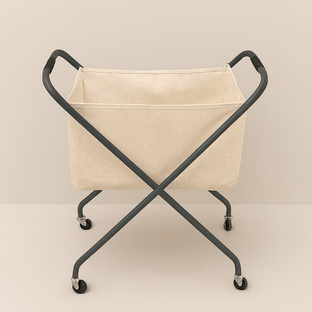Collapsible beige laundry hamper with metal X-frame and wheels, set against a smooth taupe background.