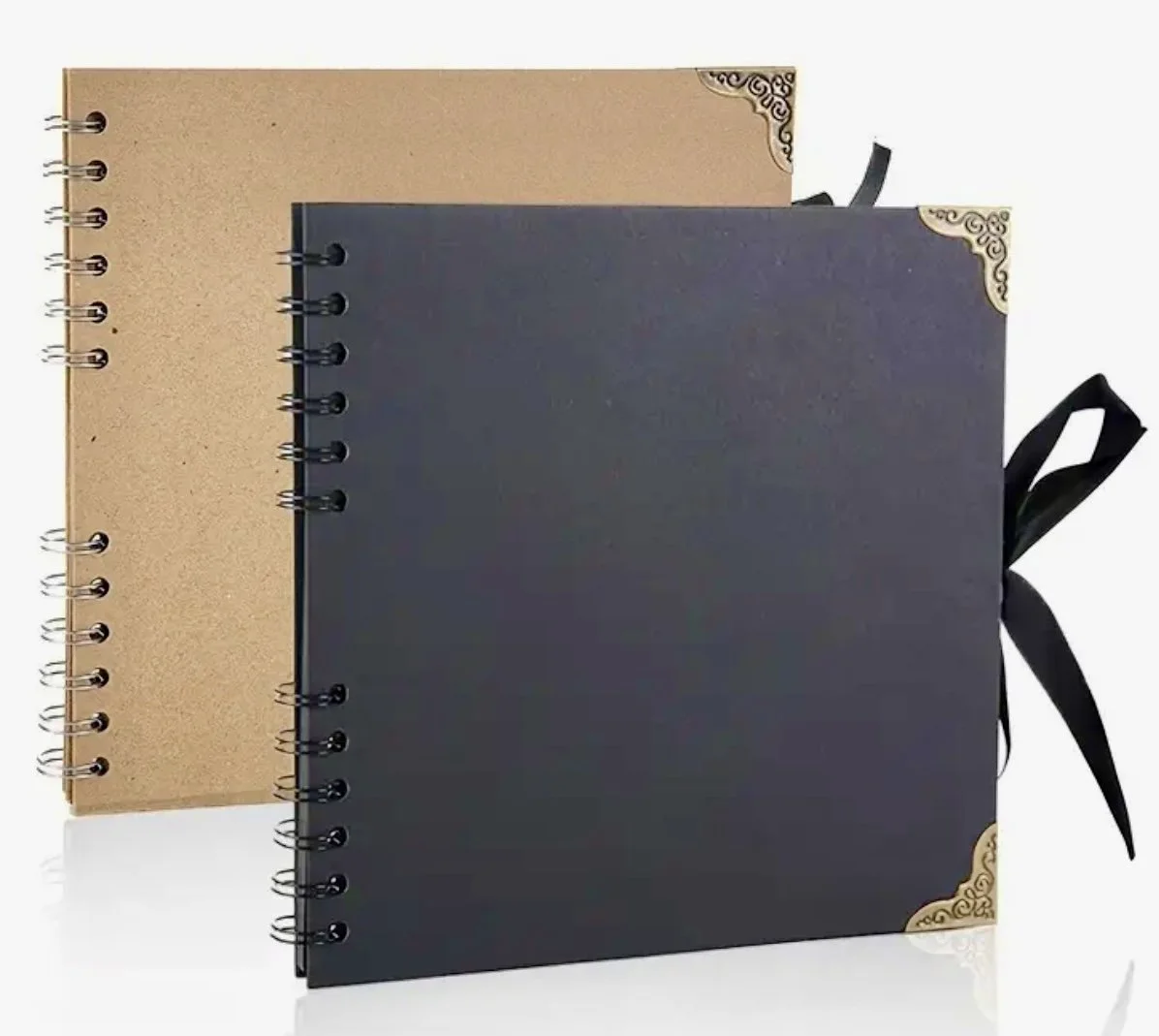 Two spiral‑bound scrapbook albums, one black with gold corners and a ribbon tie, and one plain kraft cover, shown side by side for journaling and memory‑keeping projects.