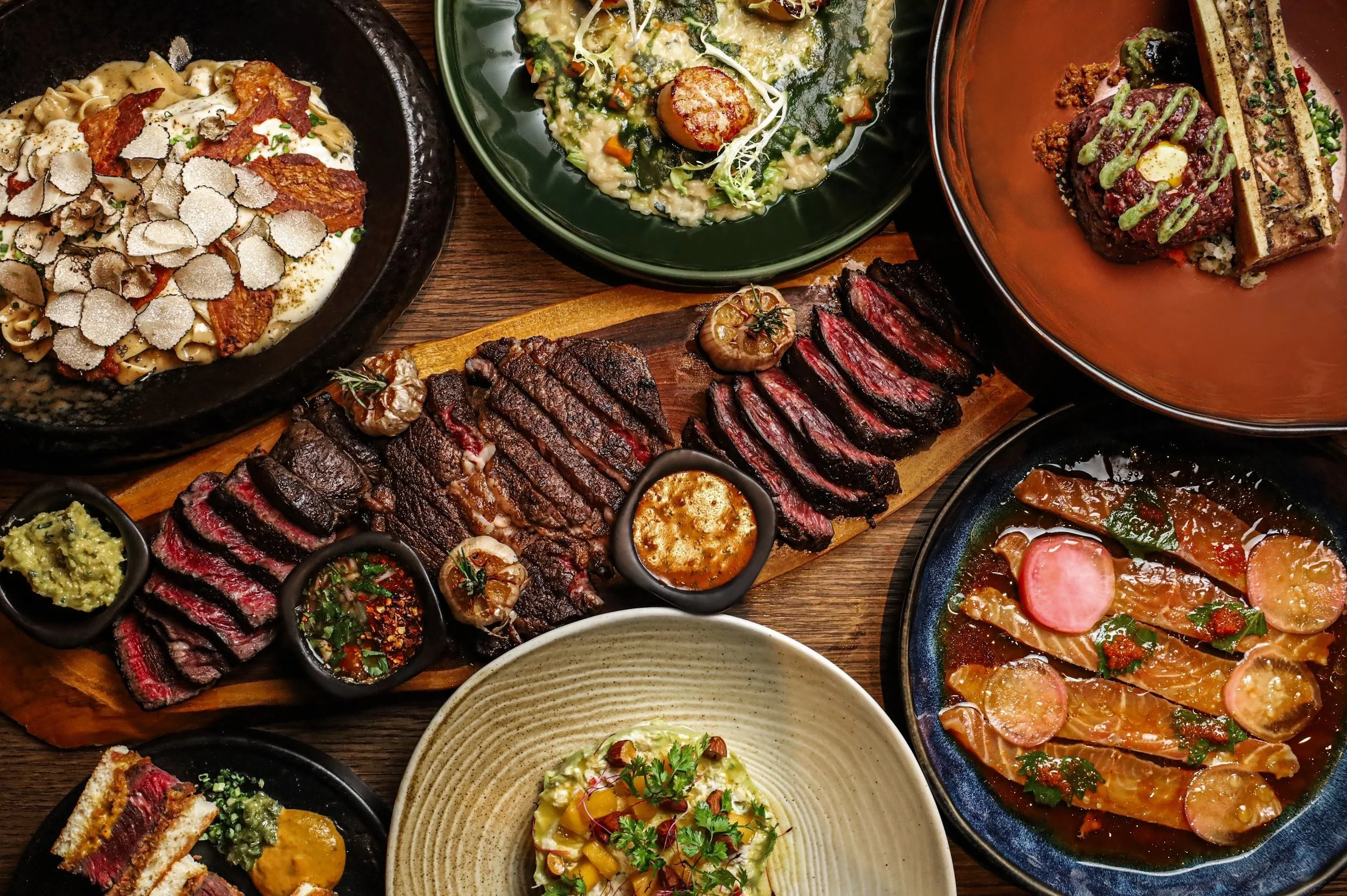 Selection of signature dishes including premium Wagyu steak, seafood and chef's specialties at Lava Fire Grill Bangkok.