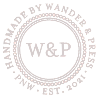 wander and press logo in ivory established 2021