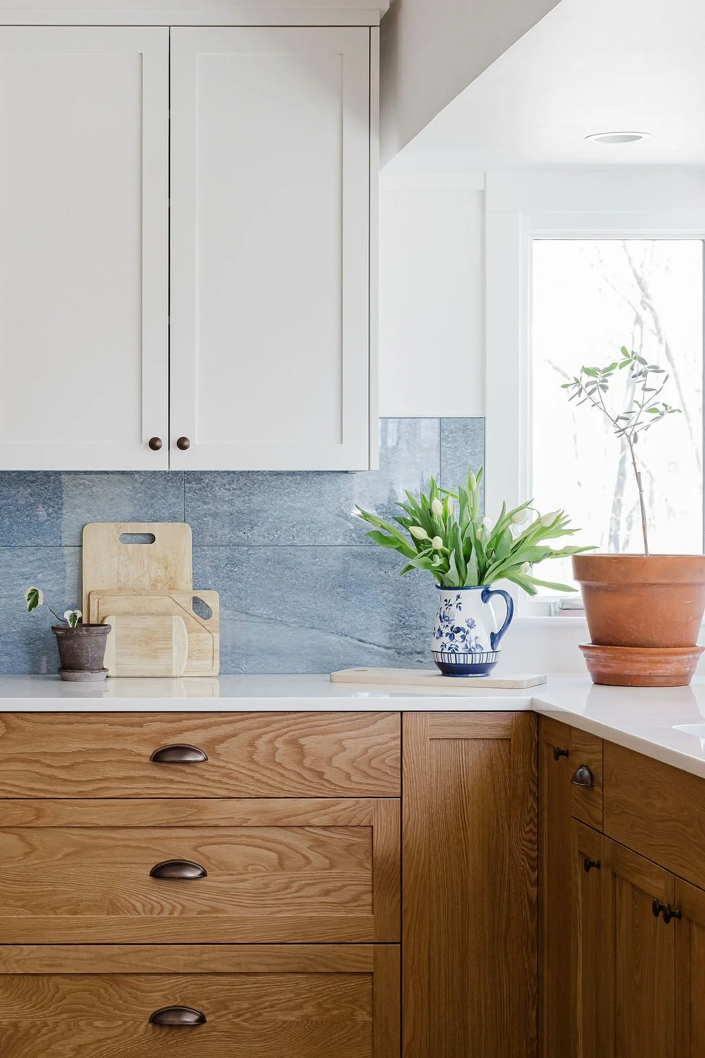 two-tone kitchen with a backsplash from Emser tile by Garvin Homes and Sean's Cabinetry