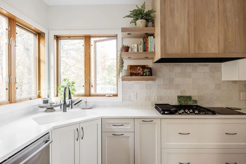sink in front of two large windows in a custom l-shape kitchen with White and Wood Kitchen Cabinets by Sean's cabinetry