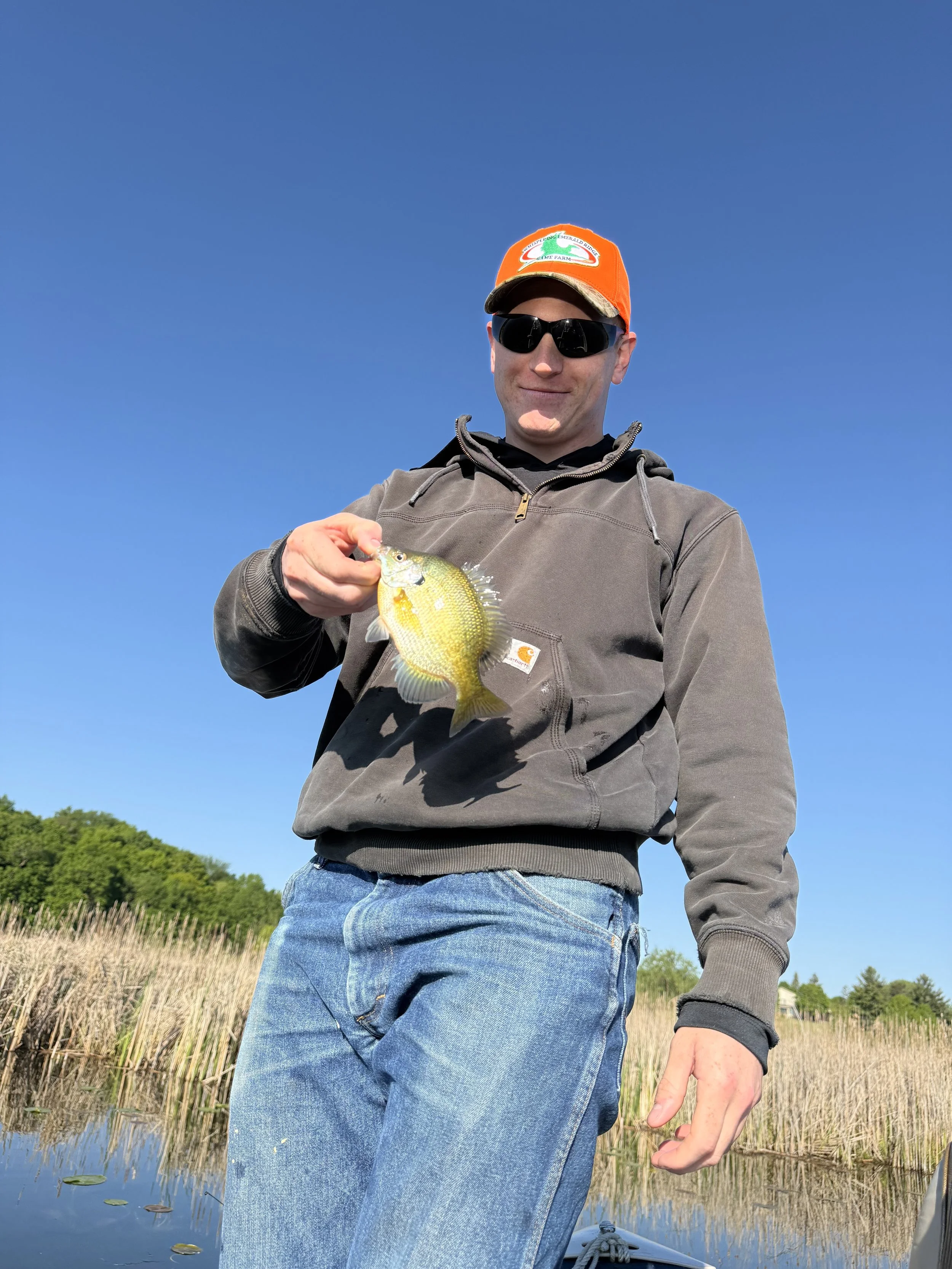 Sam Miller of Sean's Cabinetry is holding a fish he caught