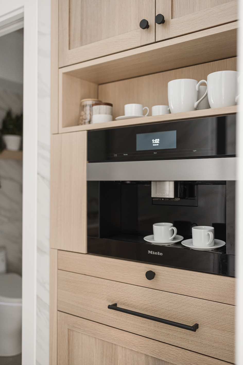 Built-in wood cabinets with integrated coffee machine and open shelving