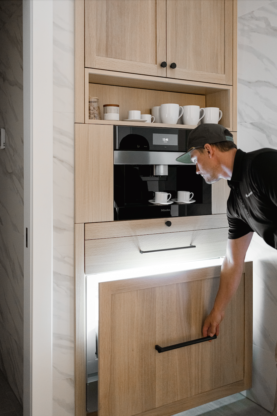 Custom wood cabinets with hidden coffee machine and pull-down cabinet door