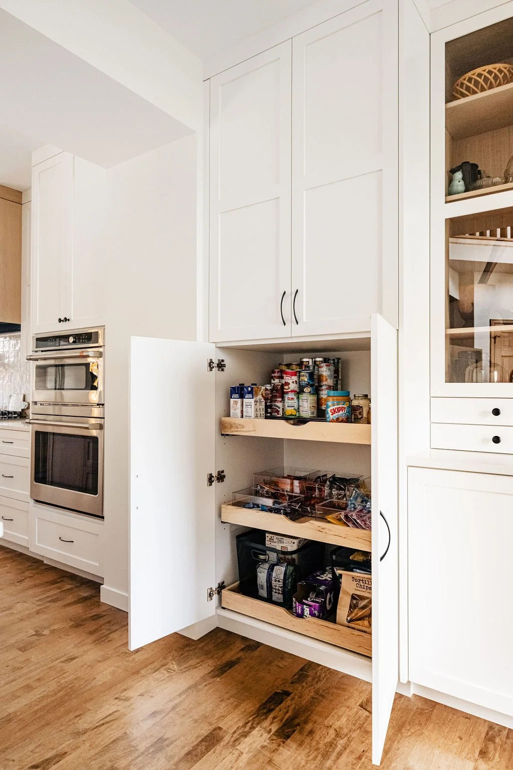 custom white kitchen cabinetry with pantry door cabinets wide-open | Sean's cabinetry
