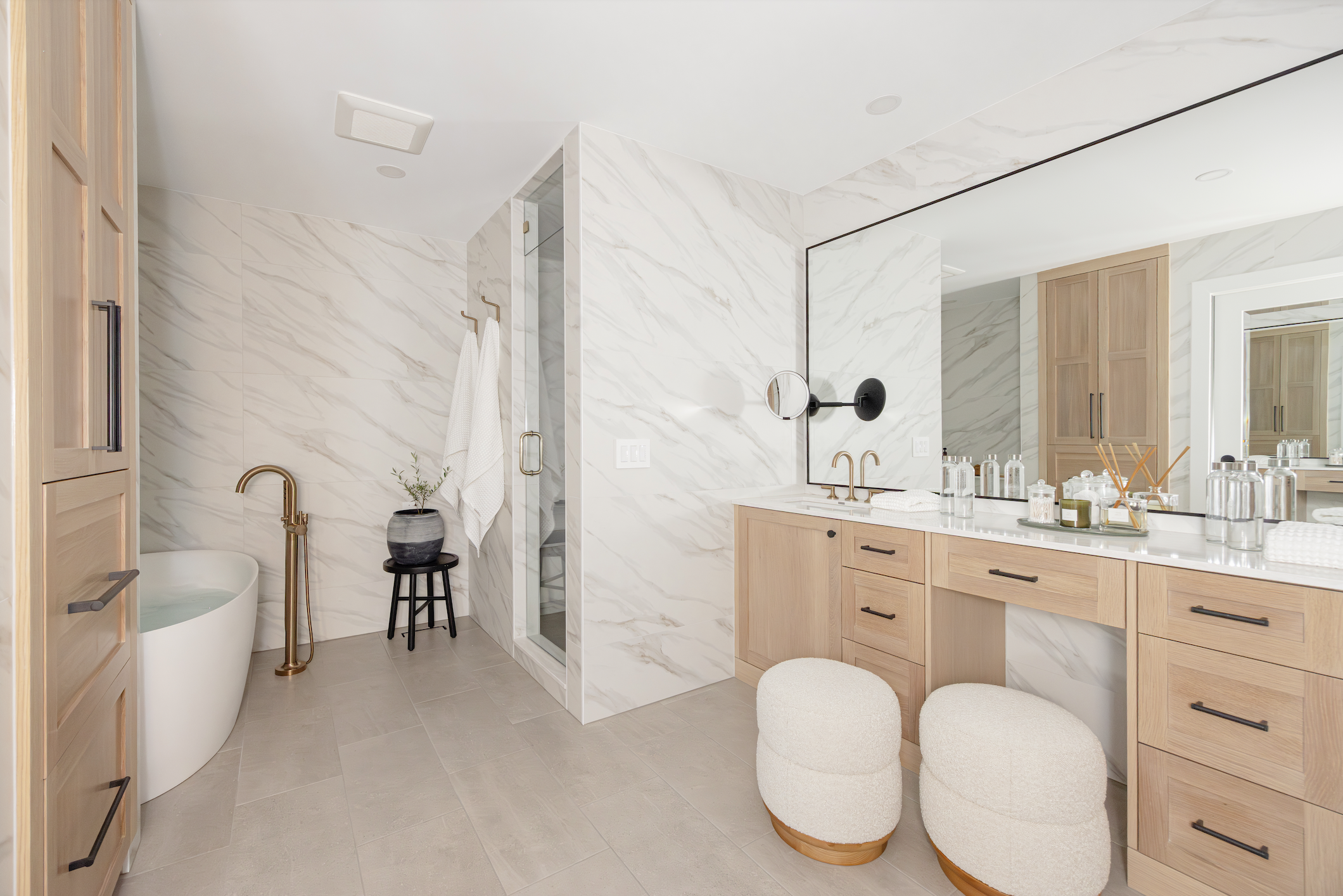 Custom bathroom cabinets in natural wood with double vanity, mirror, and spa-style layout