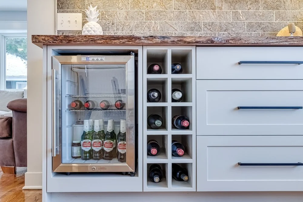a photo of high-end custom bar cabinets with a small fridge in a custom home; crafted and installed by Sean's Cabinetry