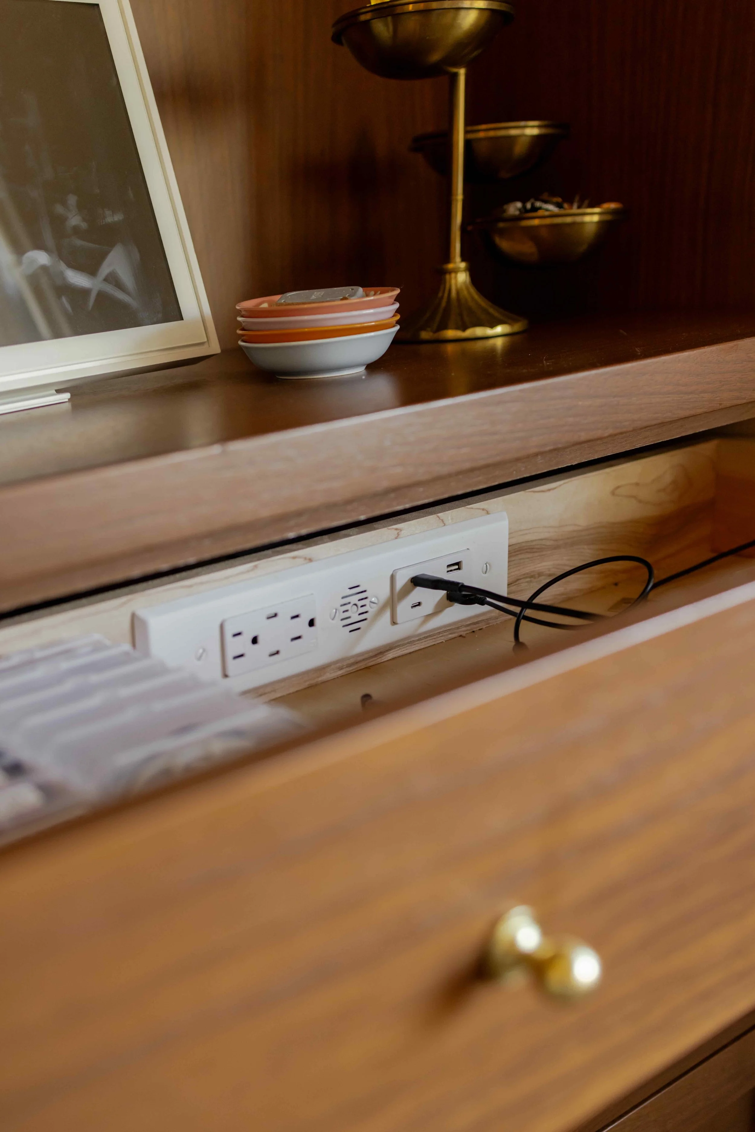 hidden charging station in the top drawer of a custom piece