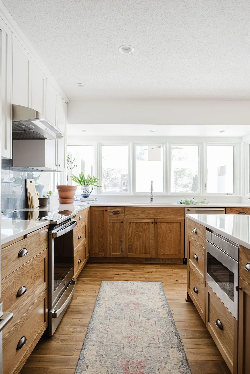 lower white oak cabinets, white oak island by Sean's Cabinetry with a quartz countertop and white oak floors