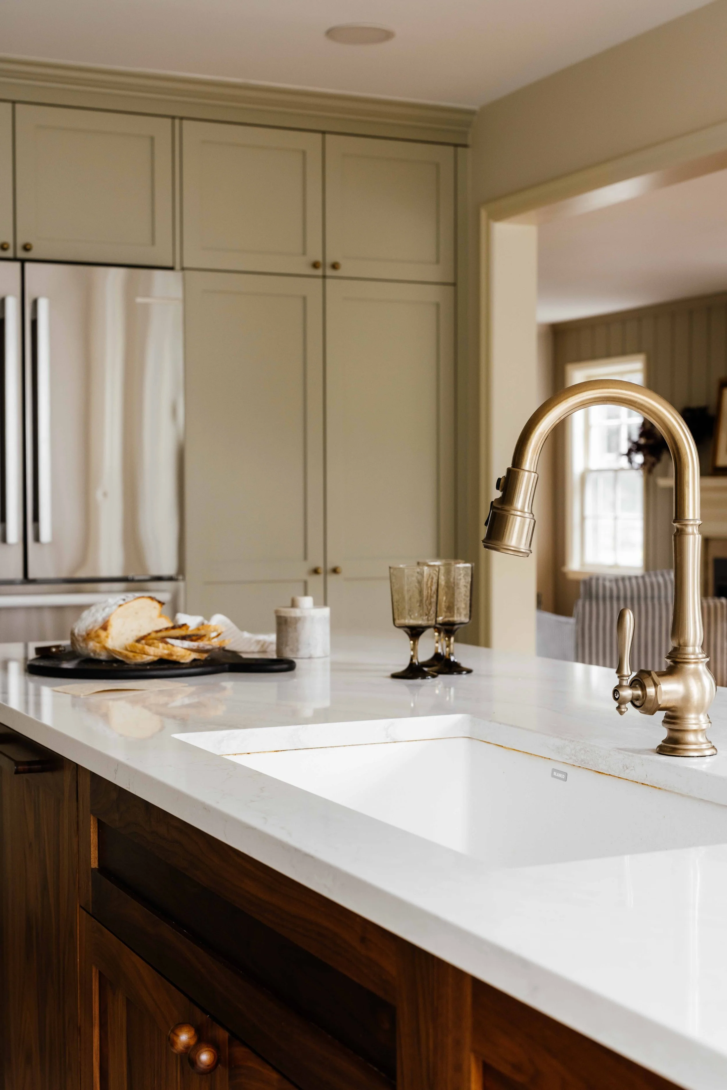 custom cabinets in Farrow and Ball Ash Grey and a close-up of an island with a sink | Sean's cabinetry