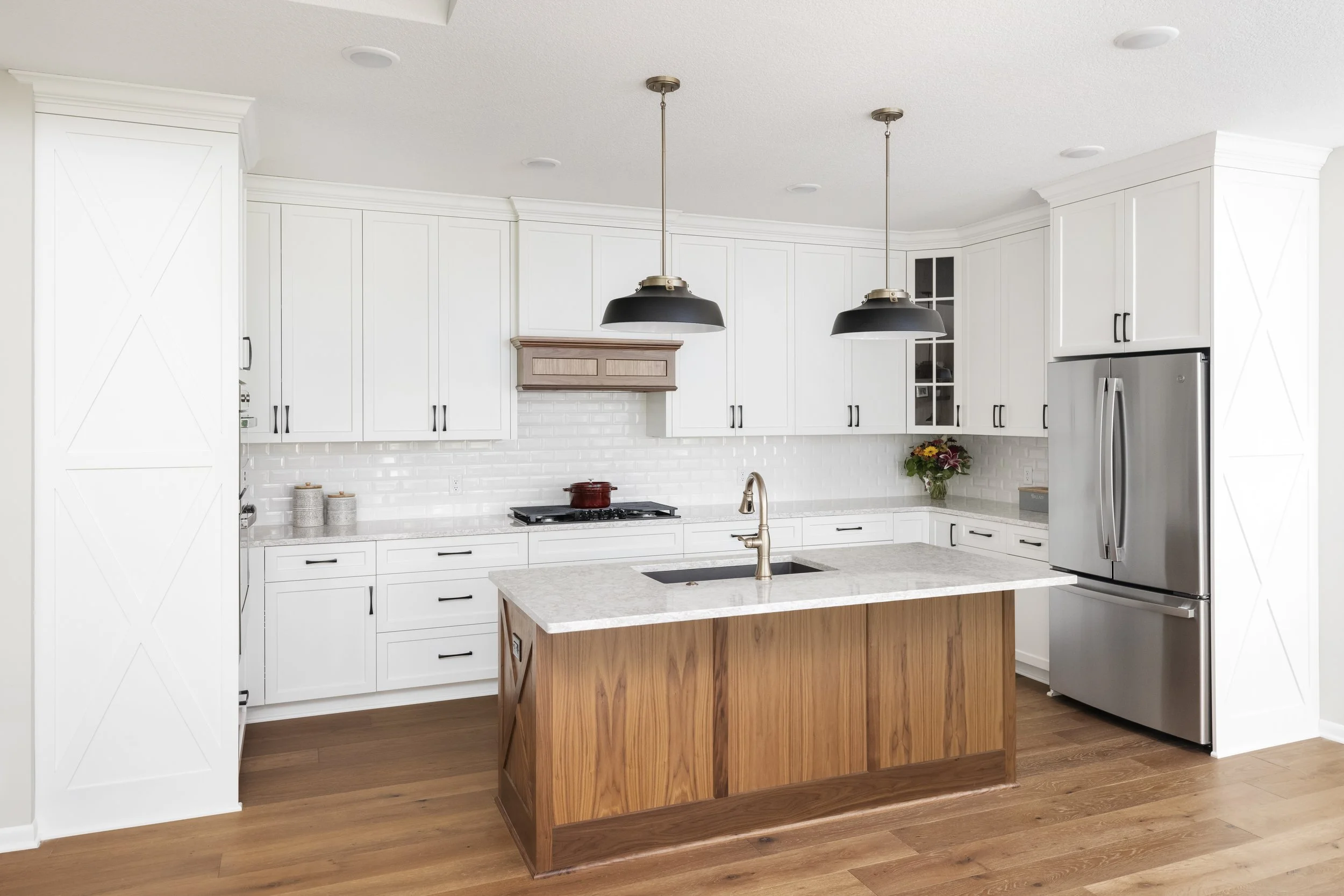 white custom cabinets by Sean's Cabinetry in a u-shaped kitchen