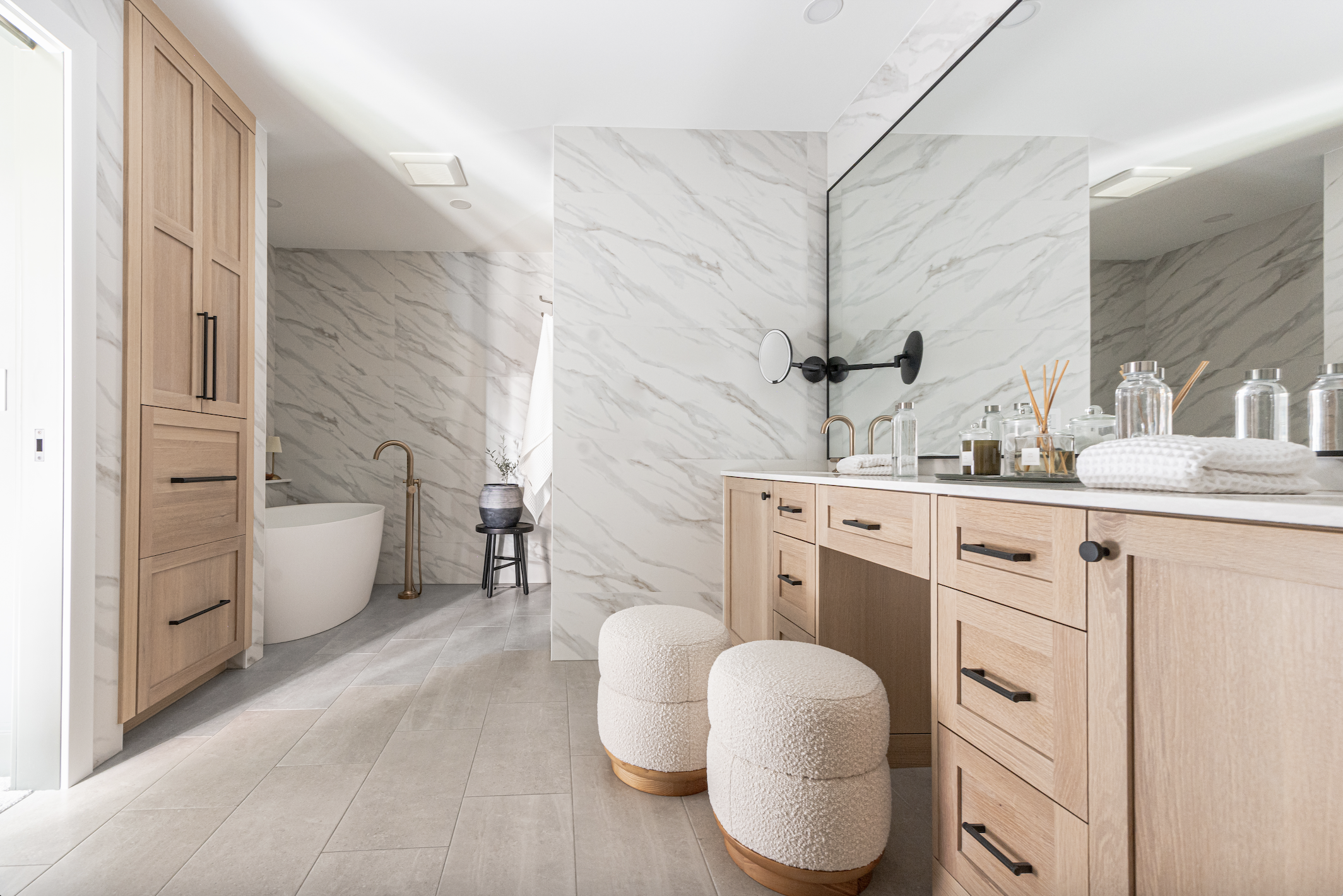 Light wood bathroom cabinets with built-in vanity, drawers, and modern marble backdrop