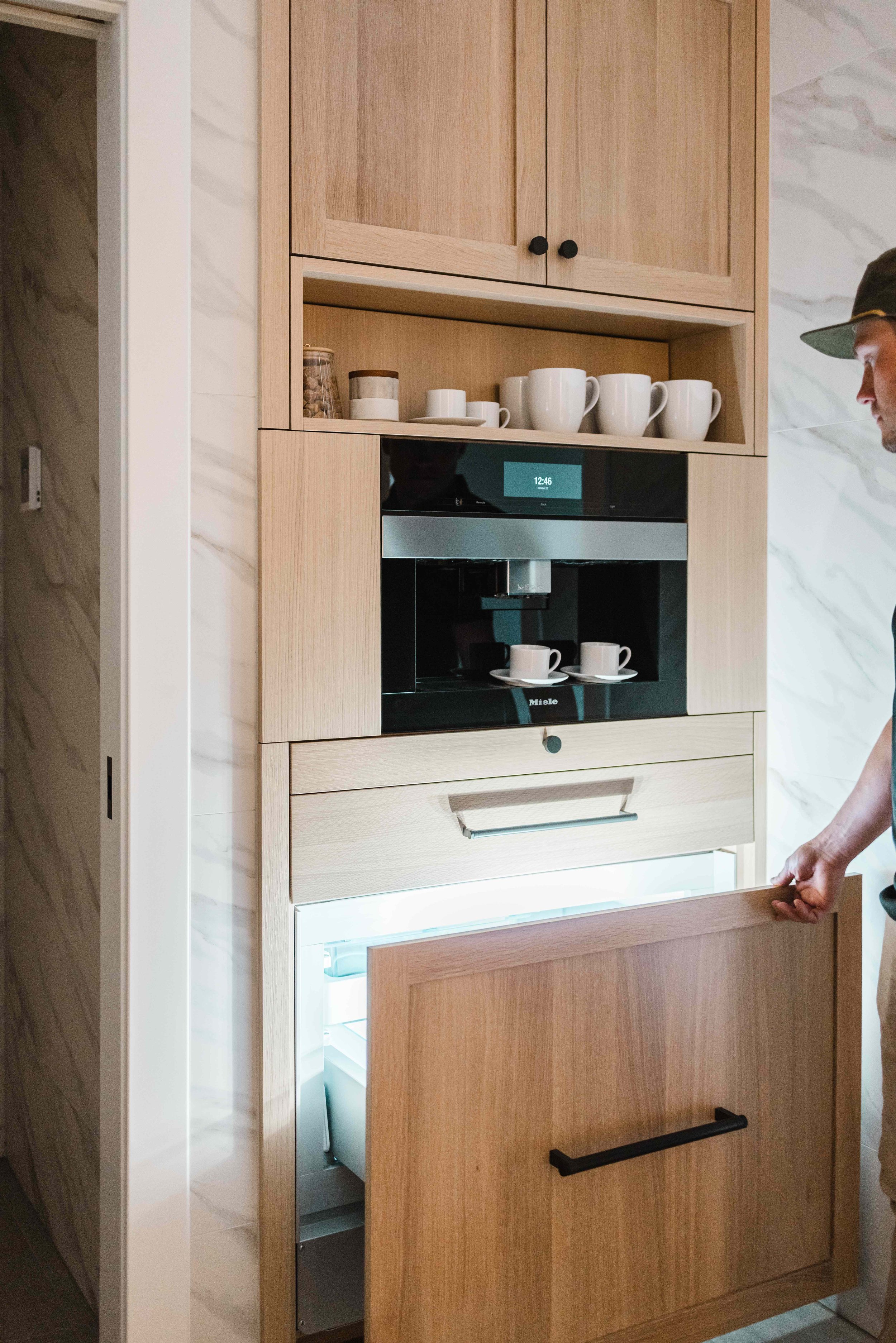 Jamie Molitor of construction2style is opening a panel ready fridge in a built in coffee station cabinet