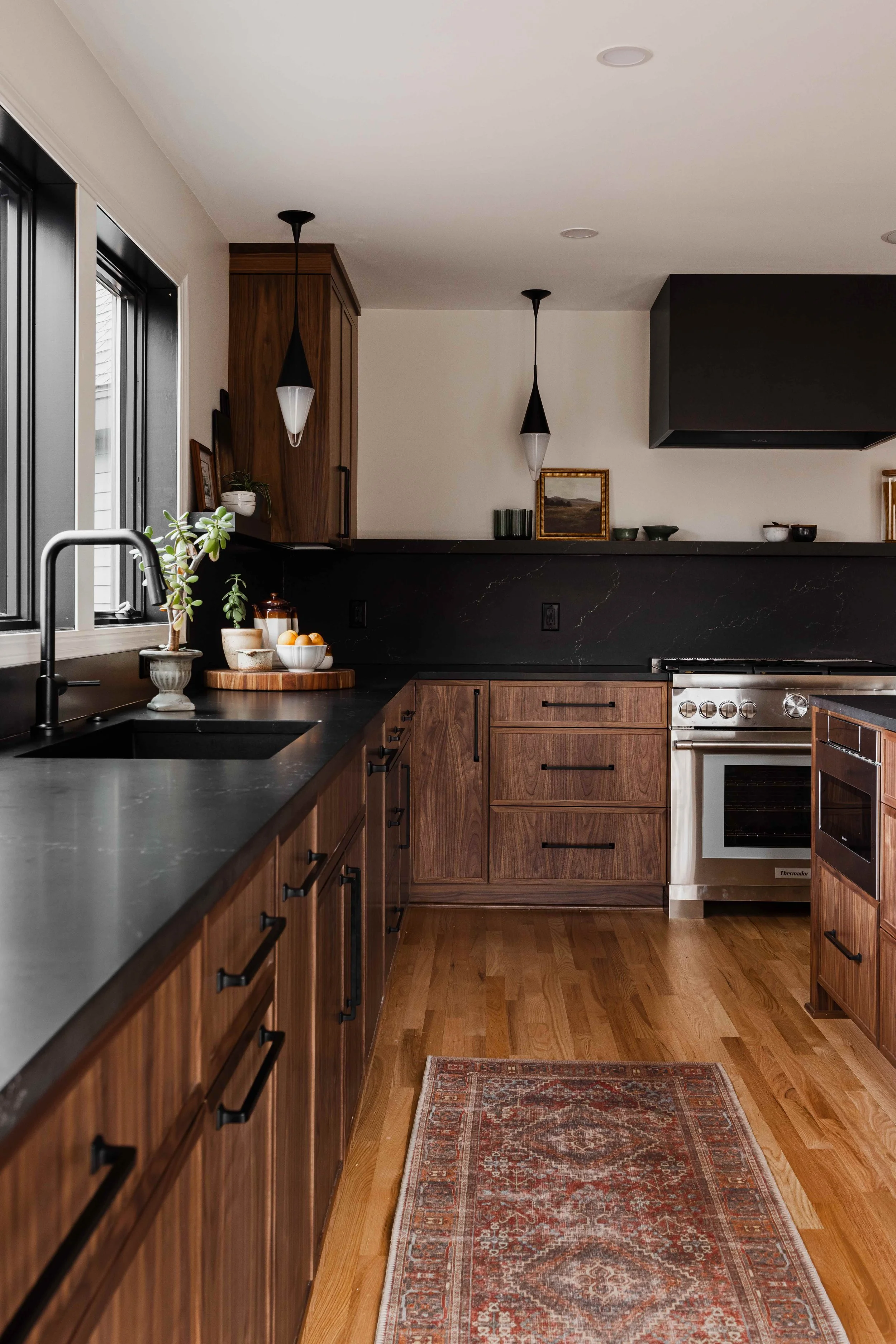 L-Shaped Layout kitchen in dark walnut by sean's cabinetry at a construction2style project in Minneapolis