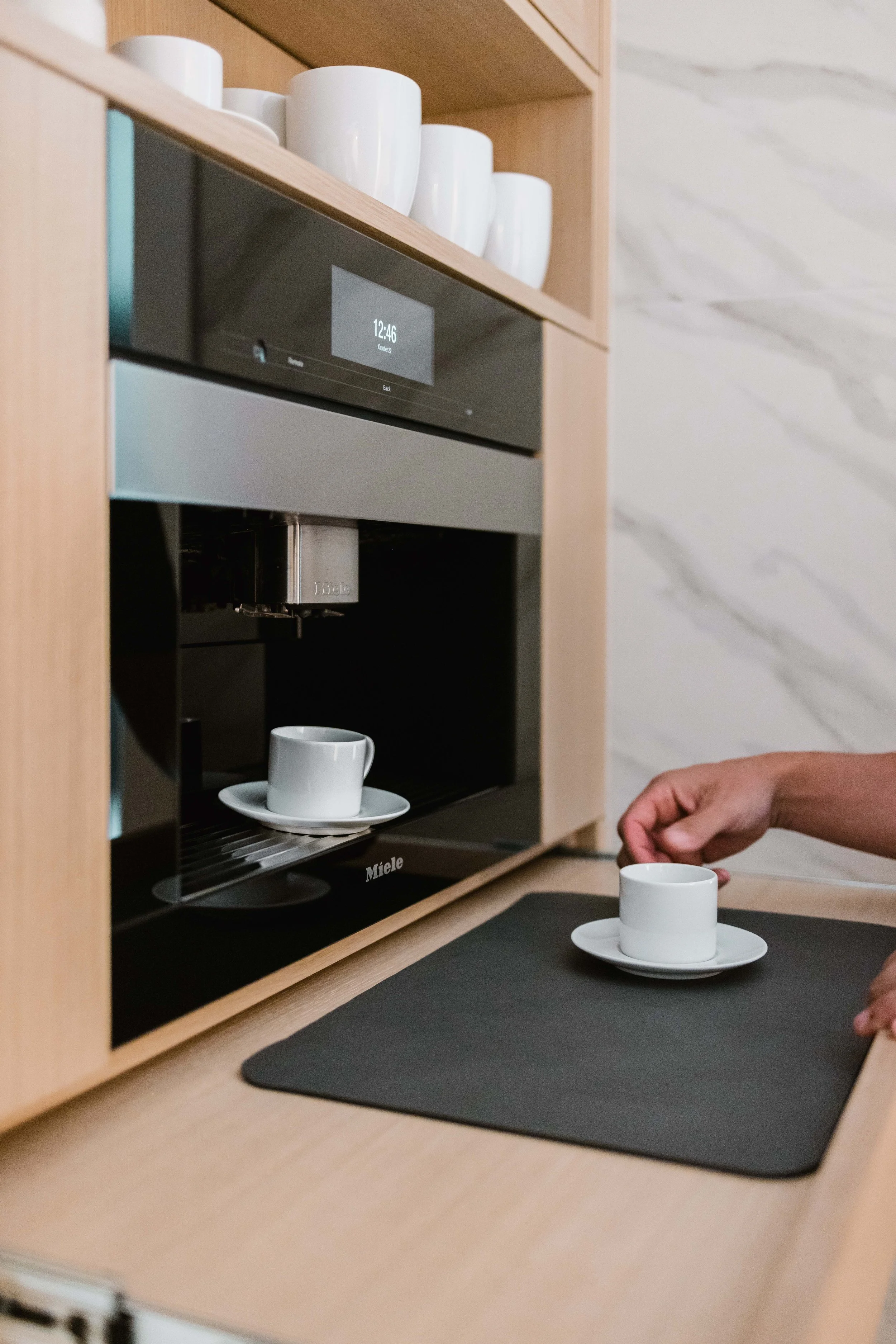 close-up of a coffee maker with an Integrated Slide Out Shelf as a part of a built in coffee station cabinet