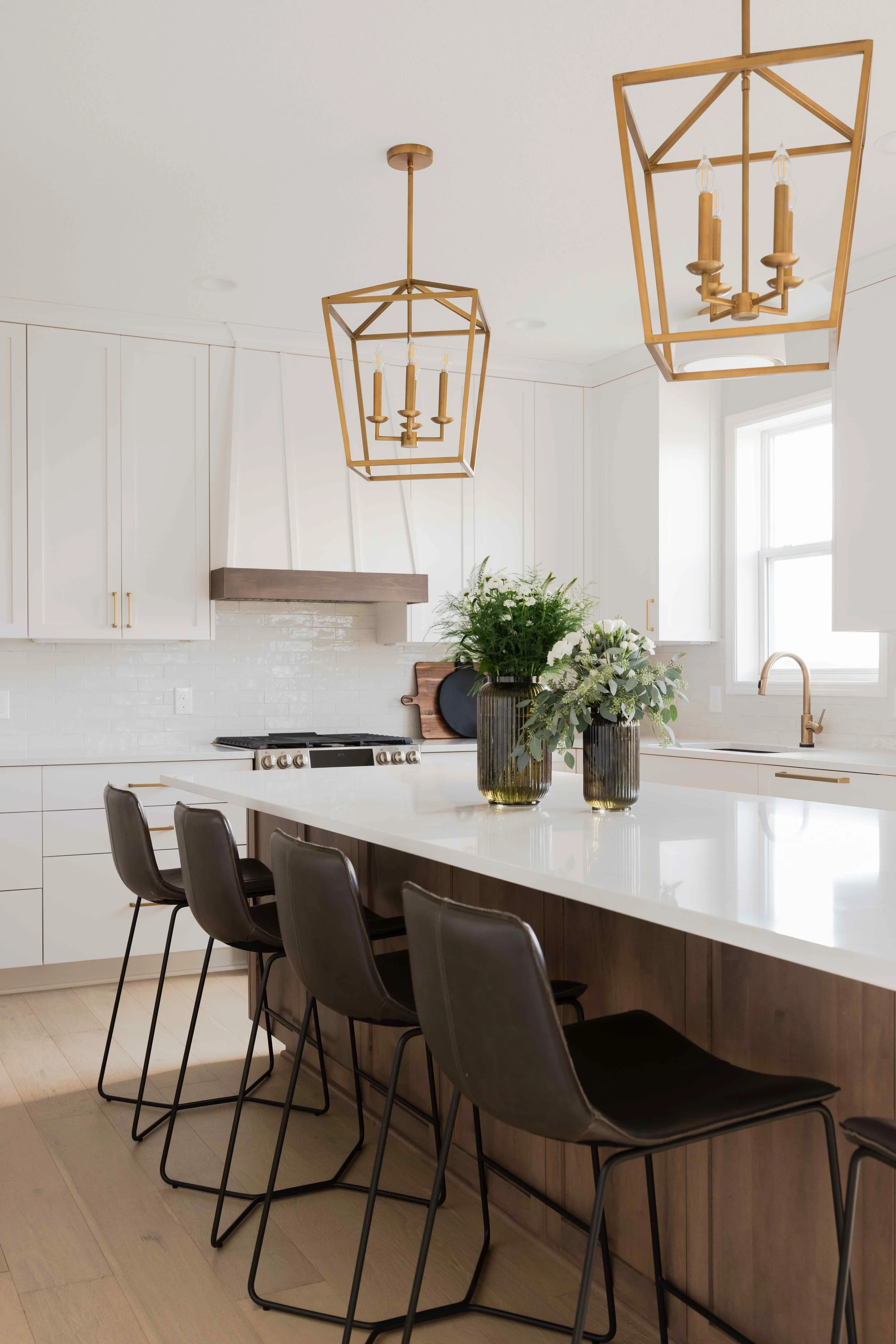 white custom cabinetry in a large kitchen with brass hardware by Sean's Cabinetry | the custom cabinetry cost was just over $ 35, 000