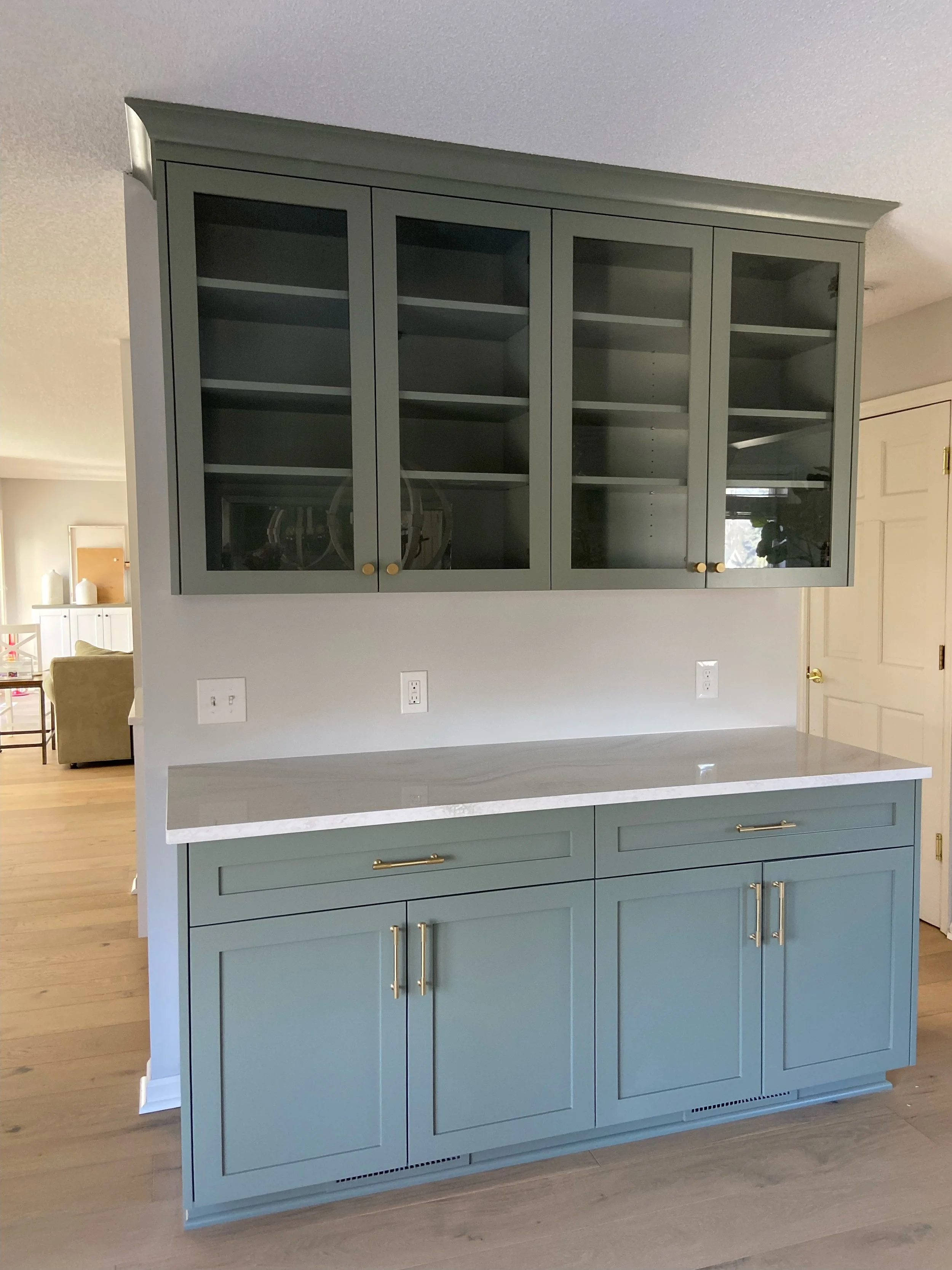 a close-up photo of a dry bar inSherwin-Williams Evergreen Fog (SW 9130)  one of the best green paint colors | Sean's Cabinetry