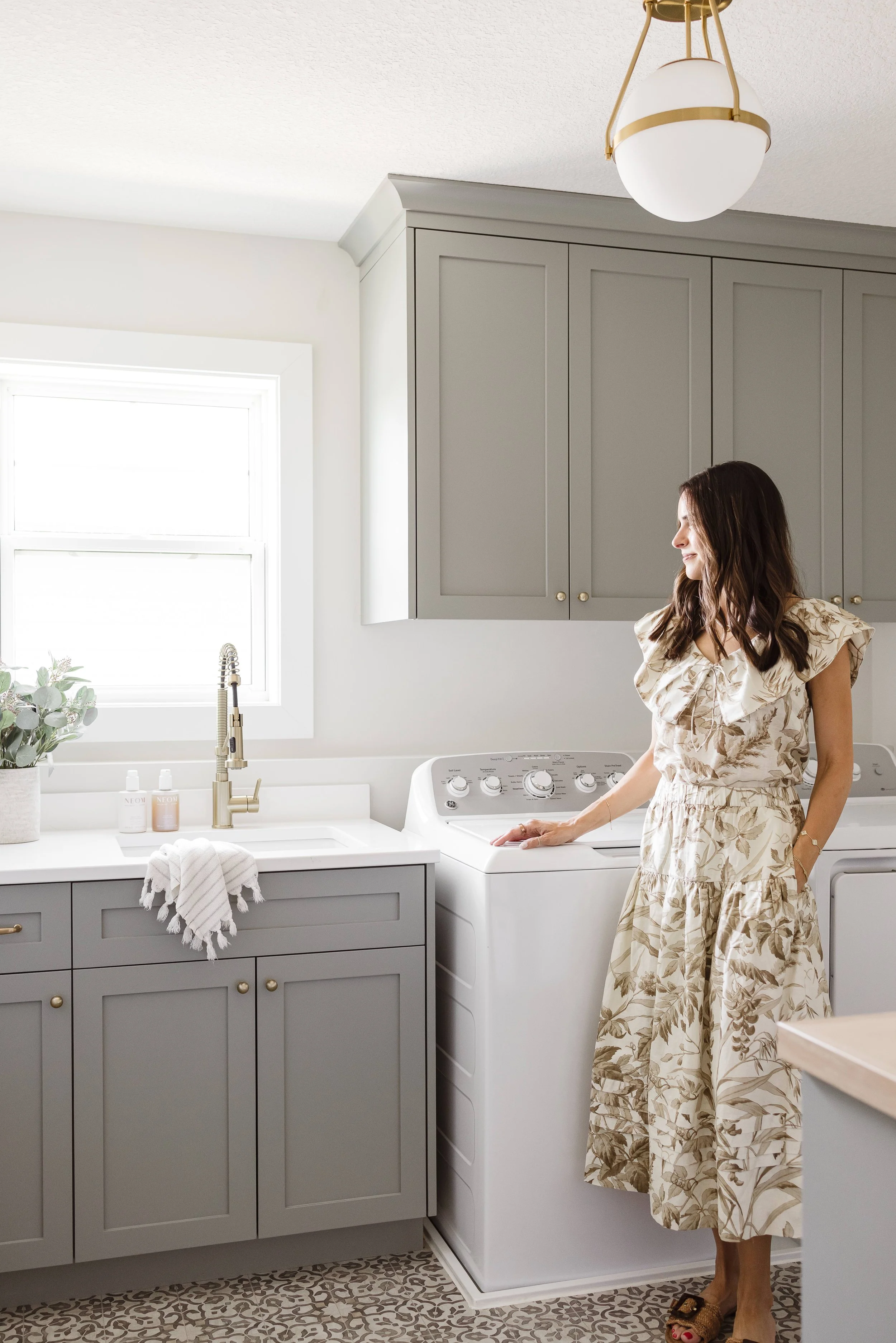 a photo of our client taylor brown by laundry room cabinetry finished in Illusive Green by Sherwin-Williams | Sean's Cabinetry