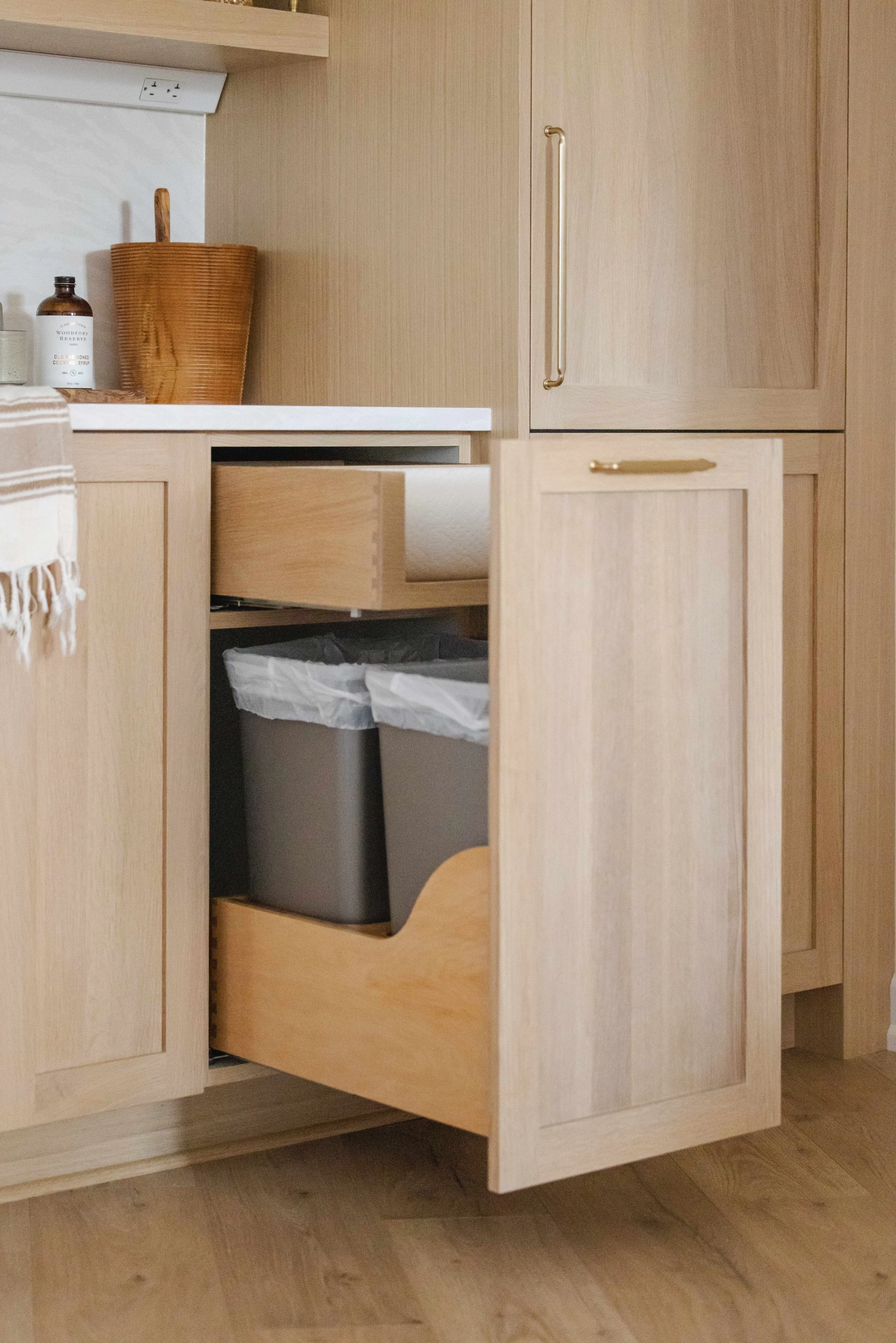White Oak Pullout Trash Container w/ Soft-Close | Custom Kitchen Cabinetry by Sean's Cabinetry in Minneapolis