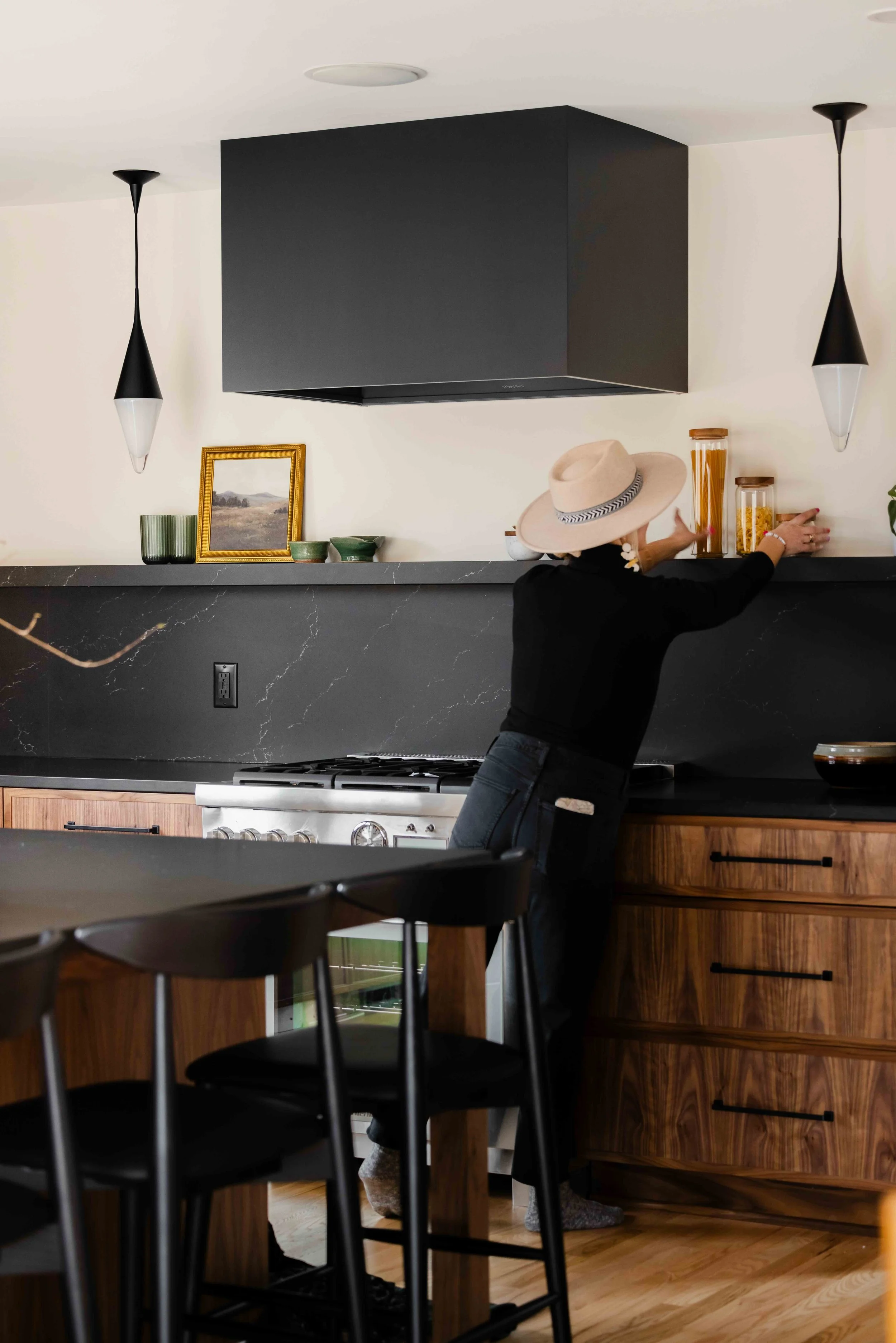 Framed black range hood with two Neena Pendants