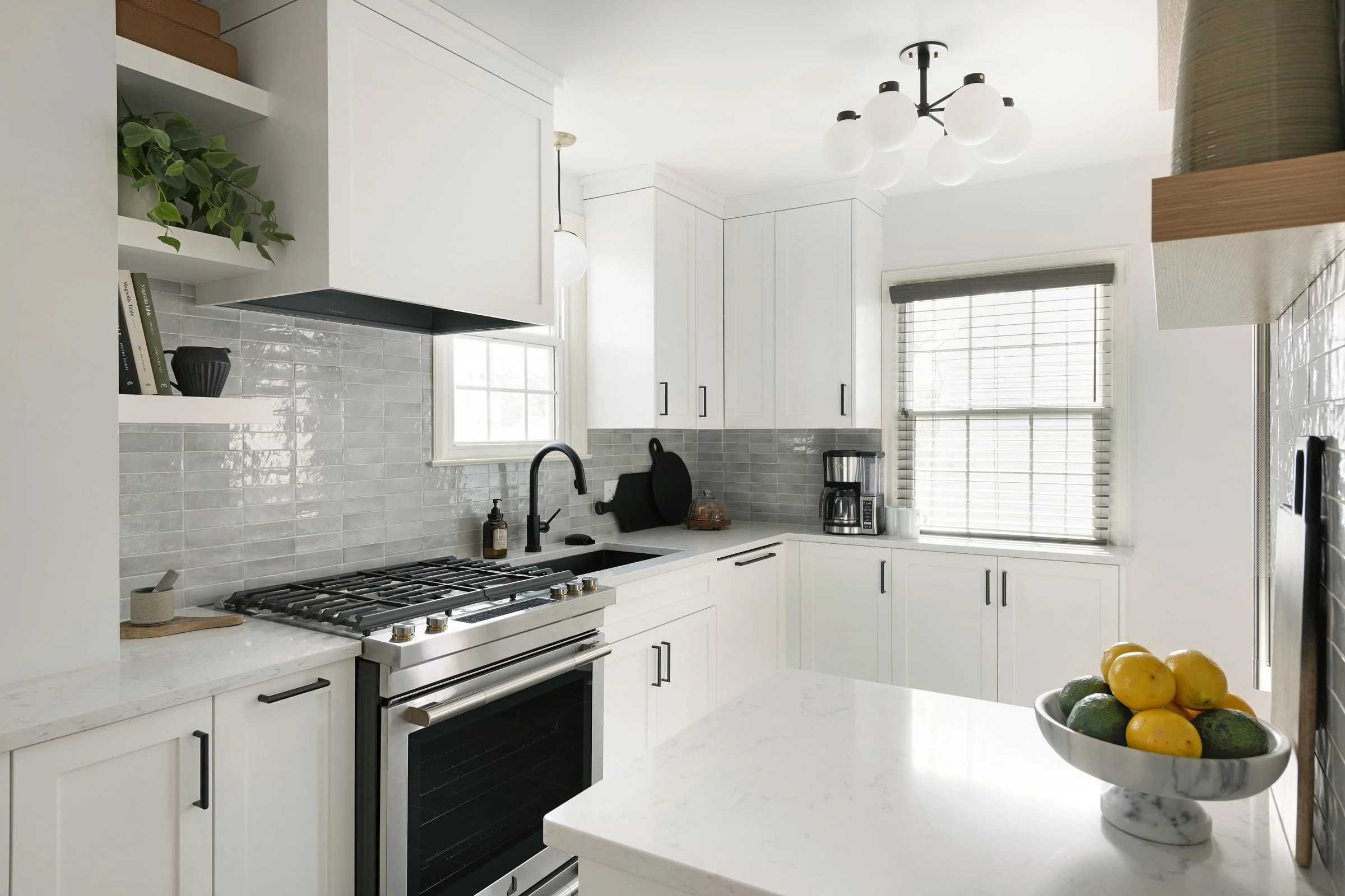 Bright white kitchen with shaker cabinets and marble island