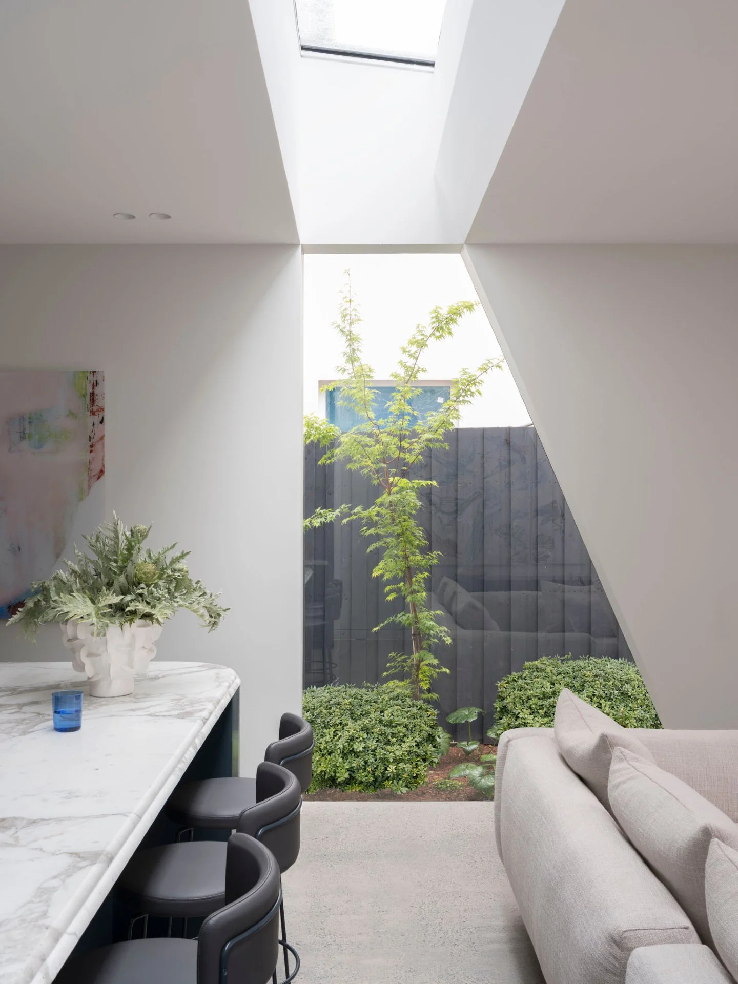 Ocean House | Kitchen Skylight &amp; Window

In the renovation, the new rear extension was deliberately separated from the original terrace by a glazed link &mdash; combining a skylight with an angular window to frame views into the side garden and m