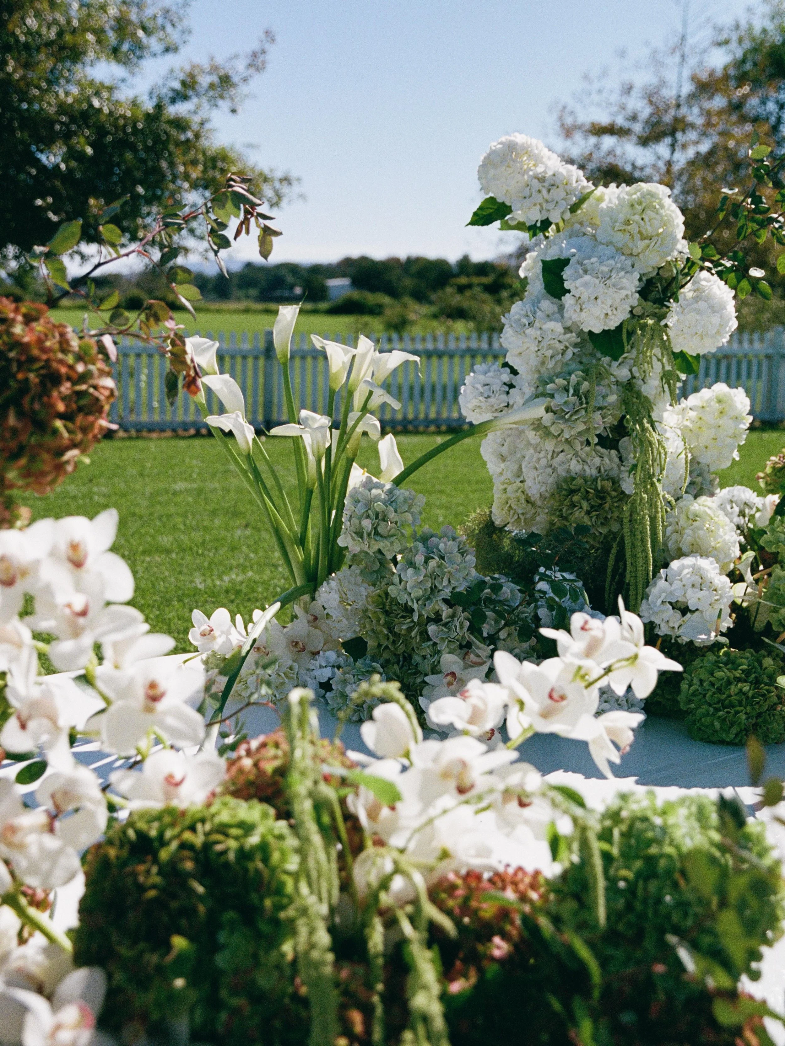 For Jack and Christie, the cricket oval became a feature. We wanted to create a ceremony space at Merribee that felt entirely unexpected.

Transformed with garden chairs and layered ottomans into a curved ceremony setting, frill umbrellas, parasols, 