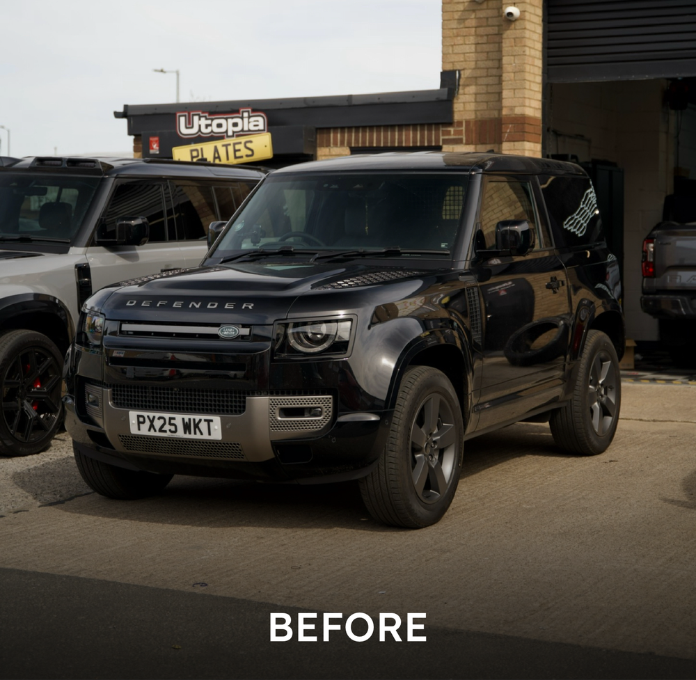 Before: black Land Rover Defender 90 with the factory silver front bumper and grille